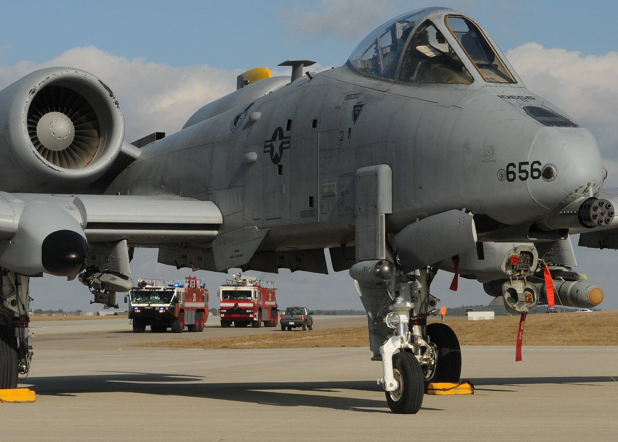 SPANGDAHLEM AIR BASE, Germany – An A-10 Thunderbolt II rests on the flightline as fire trucks arrive on scene for a major accident response exercise Feb. 8. The exercise tested base members’ ability to respond to an emergency involving aircraft on the flightline. (U.S. Air Force photo/Staff Sgt. Benjamin Wilson)