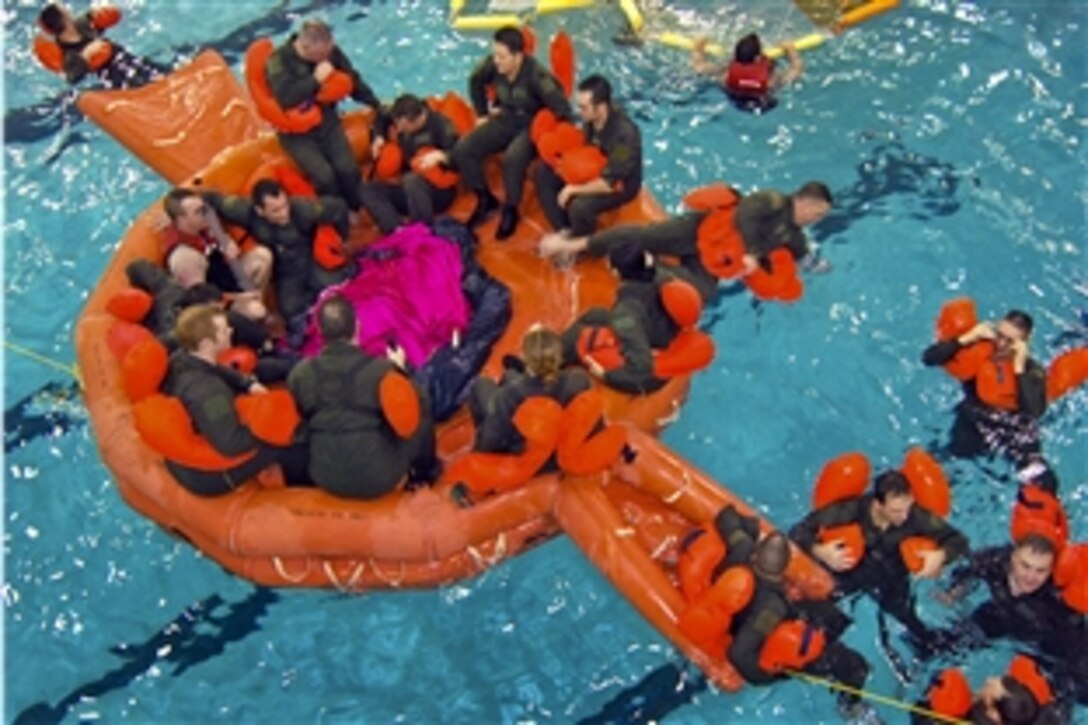 U.S. Air Force aircrew members receive instruction on the use of a 20-person life raft during water survival training at the Cobb Aquatic Center in Marietta, Ga., Feb. 4, 2011. The airmen are assigned to the 94th Airlift Wing.