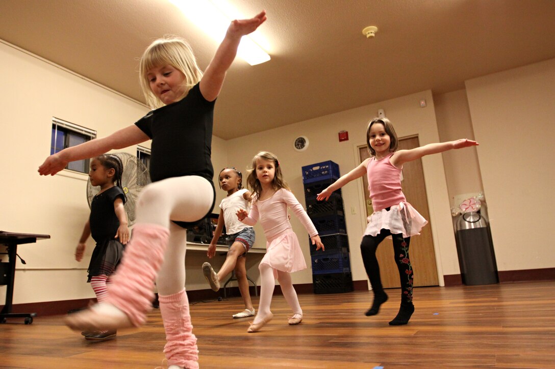 Children from Camp Pendleton warm-up before their free ballet lessons provided by the base’s Stuart Mesa Community Center, Feb. 9.  Throughout the class, children not only learn the basic fundamentals of ballet, but they also learn gymnastics by performing forward rolls and cart-wheels. At the conclusion of each session, the students get to show off their own moves during the freestyle portion of the class.