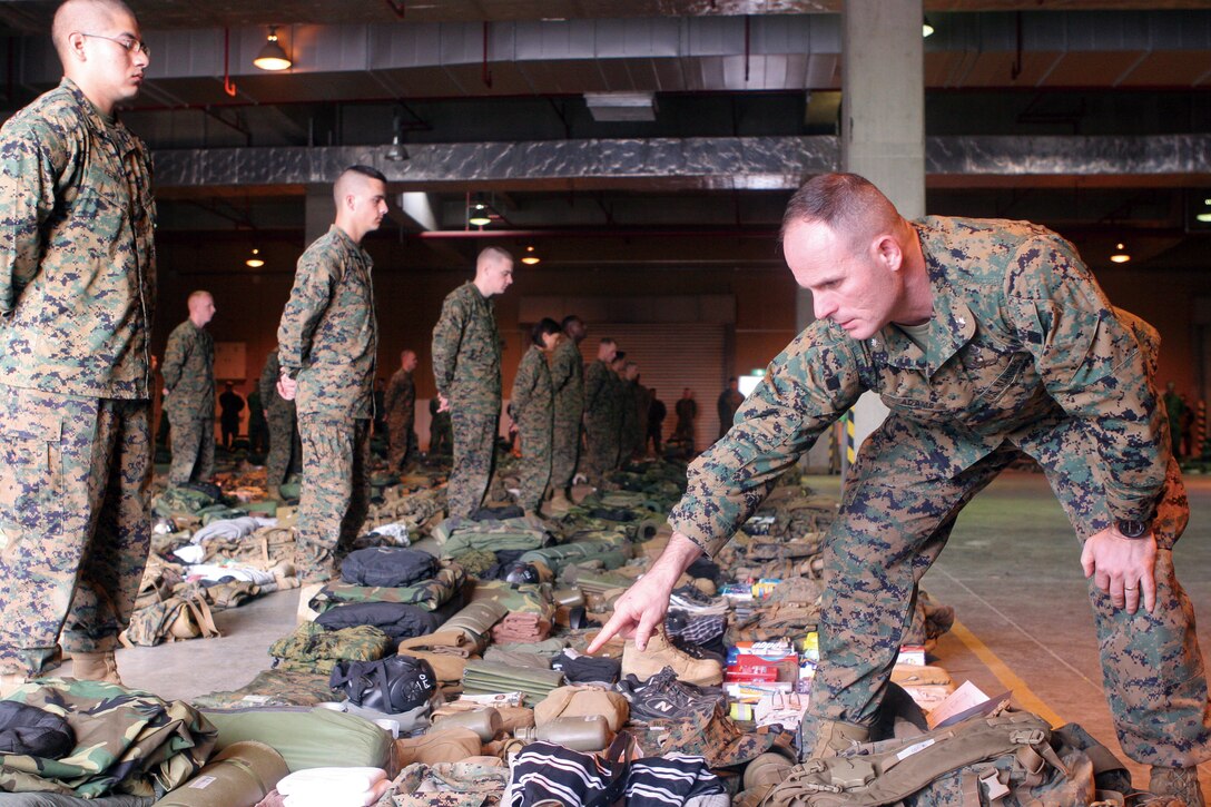 Lt. Col. Ted Adams, commander of 9th Engineer Support Battalion, 3rd Marine Logistics Group, III Marine Expeditionary Force, inspects gear of the Marines departing for Exercise Forest Light Feb. 10. Adams thoroughly inspects the gear to ensure that Marines have the proper and serviceable equipment for the exercise. Exercise Forest Light is an annual bilateral exercise between U.S. Forces and Japan Ground Self-Defense Force.
