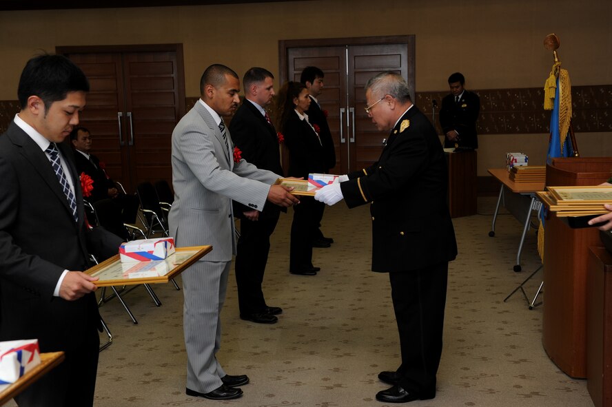 Mr. David Worley, Criminal Investigator from the 18th Security Forces Squadron, Kadena Air Base, accepts a letter of appreciation from Mr. Akira Namihira, Senior Police Superintendent, Director of Community Safety Department, at the Okinawa Prefectural Police Headquarters in Naha, Okinawa, Feb. 10.

The crime prevention program was established by the Juvenile Section of the Okinawa Prefecture Police along with the collaboration and support of the 18th SFS. Working together, 18th SFS and OPP have provided crime prevention classes to more than 500 students with the goal of informing and educating school-aged children about crime prevention and crime standards both on and off base. As a result, the crime rate involving juvenile, SOFA-status personnel has gone down both on and off base. 
 (U.S. Air Force Photo/Junko Kinjo) 
