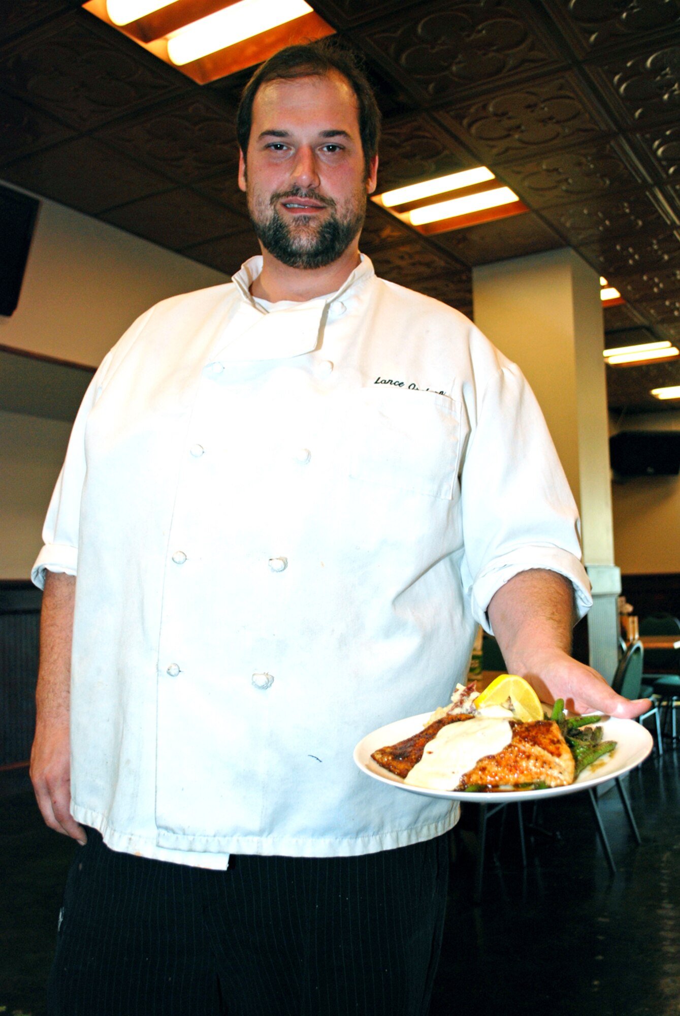 The new Columbus Club Head Chef Lance Orsborn shows off this blackened catfish with white wine cream sauce in the newly remodeled Indys restaurant on Feb. 8. The dish is one of several additions to Indys to the menu and can be enjoyed in the remodeled dining area. (U.S. Air Force photo/Jana Hall)