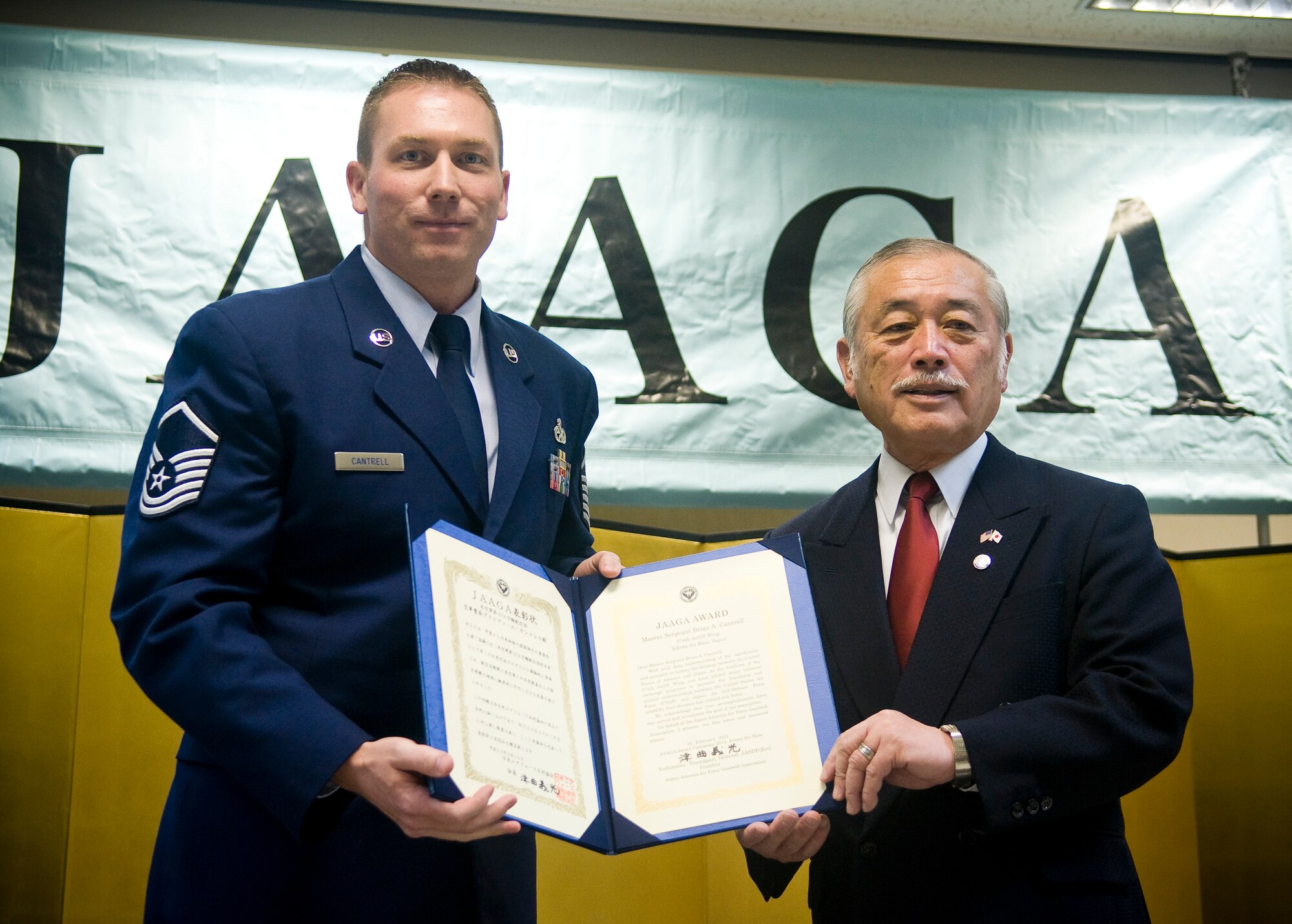 IRUMA AIR BASE, Japan -- Master Sgt. Brian Cantrell, 374th Maintenance Squadron productions superintendent, Yokota Air Base, Japan, receives a Japan-America Air Force Goodwill Association award from JAAGA President, Yoshimitsu Tsumagari here Feb. 10. Sergeant Cantrell was recognized for his contributions as project officer during several bilateral events for the 374th MXS during 2010. (U.S. Air Force photo/Staff Sgt. Chad Strohmeyer)