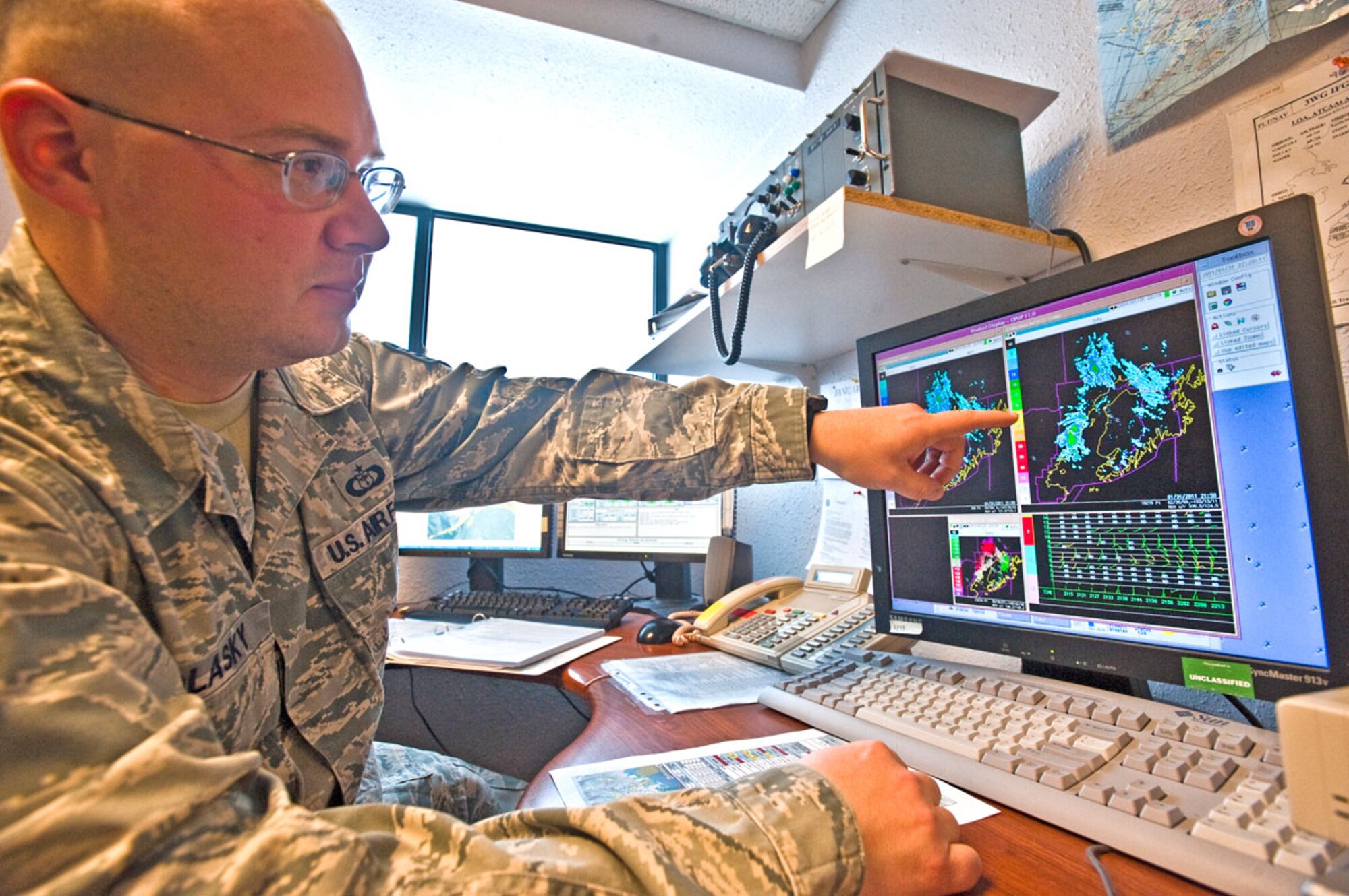 Air Force Staff Sgt. Raymond Polasky, 3rd Operational Support Squadron, 3rd Wing, points out changes in weather patterns on radar. The weather flight uses tools like weather sensors, sattelites and radar to accurately forecast for eight different airframes. (U.S. Ari Force photo/Airman 1st Class Jack Sanders)