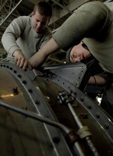 Airman 1st Class Colten Papke and Airman 1st Class David Peterson torque bolts on a KC-135 Stratotanker engine Feb. 8, 2011, at Grant County International Airport in Moses Lake, Wash. Airman Papke and Airman Peterson are maintainers with the 92nd Aircraft Maintenance Squadron. Earlier, they were working on removing the engine from the wing so they could perform more in-depth maintenance on the part. Maintenance Airmen are working here on two week rotations while the runway at Fairchild Air Force Base, Wash., gets repaired. (U.S. Air Force Photo/Senior Airman Natasha E. Stannard)