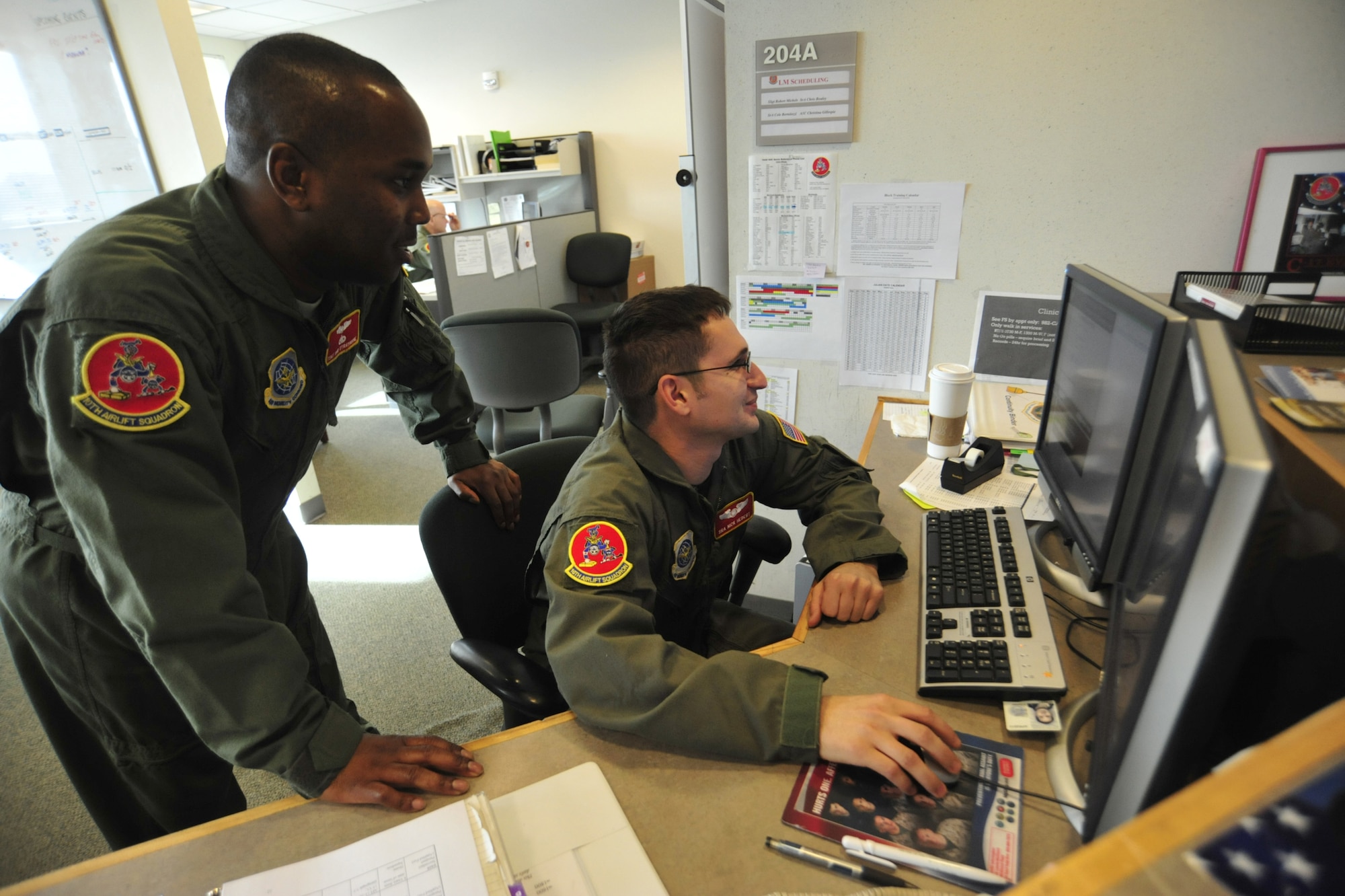 Technical Sgt. Ron Strayhorne, left, and Senior Airman Nicholas Hebert, both 10th Airlift Squadron loadmasters, discuss upcoming missions and training requirements Feb. 9 at Joint Base Lewis-McChord, Wash. Loadmasters are responsible for loading and off-loading aircraft functions and performing pre-flight and post-flight of aircraft and aircraft systems. (U.S. Air Force photo/Airman 1st Class Leah Young)