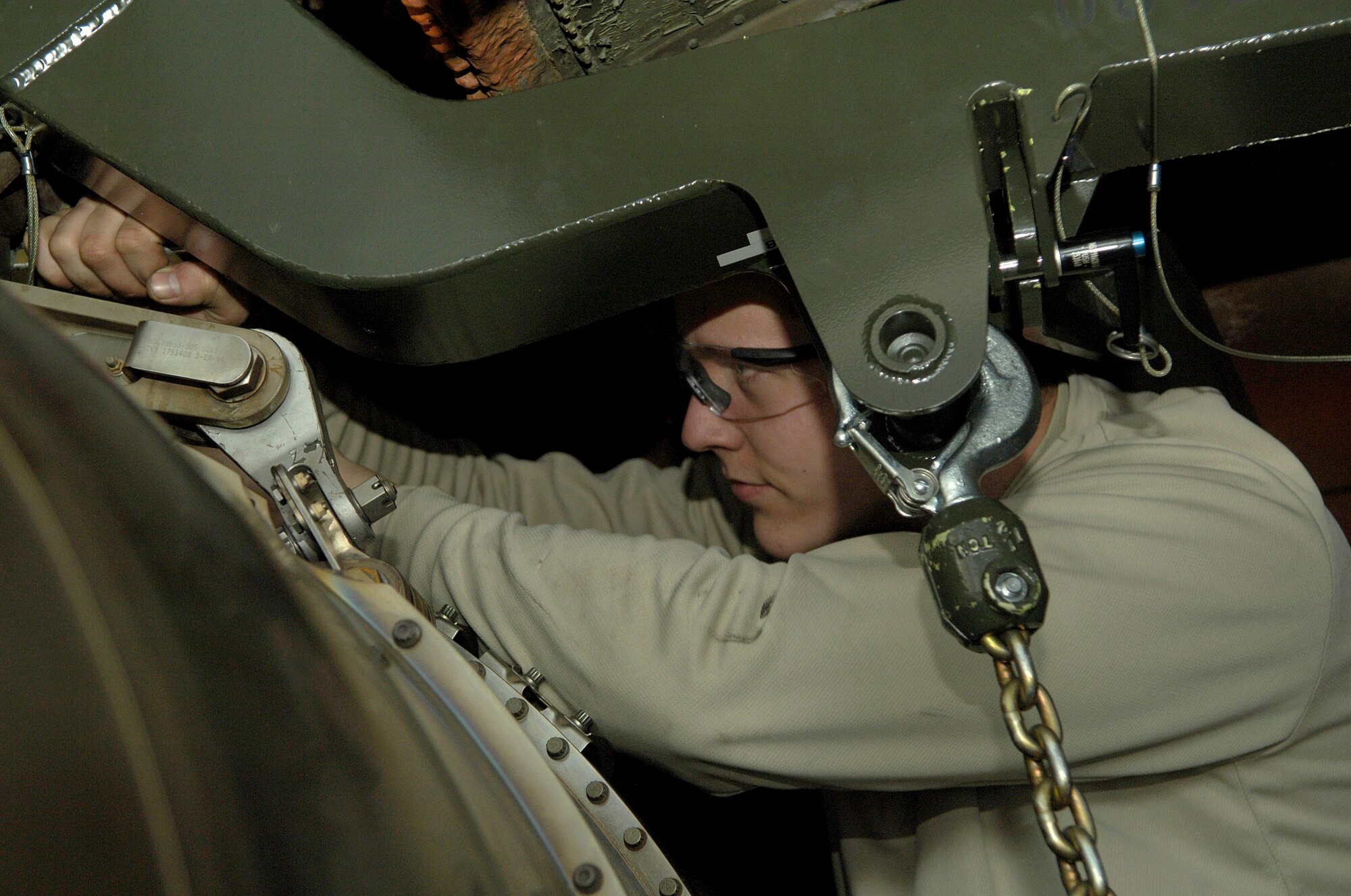 Airman 1st Class David Peterson removes mount bolts on a KC-135 Stratotanker engine Feb. 8, 2011 at Grant County International Airport in Moses Lake, Wash.  Airman Peterson is an aircraft maintainer with the 92nd Aircraft Maintenance Squadron and is on temporary duty in Moses Lake for two weeks. Maintenance Airmen are working here on two week rotations while the Fairchild runway gets repaired. (U.S. Air Force photo/ Senior Airman Natasha E. Stannard)