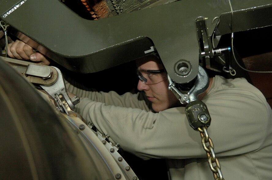 Airman 1st Class David Peterson removes mount bolts on a KC-135 Stratotanker engine Feb. 8, 2011 at Grant County International Airport in Moses Lake, Wash. Airman Peterson is an aircraft maintainer with the 92nd Aircraft Maintenance Squadron and is on temporary duty in Moses Lake for two weeks. Maintenance Airmen are working here on two week rotations while the runway at Fairchild Air Force Base, Wash., gets repaired. (U.S. Air Force Photo/Senior Airman Natasha E. Stannard) 