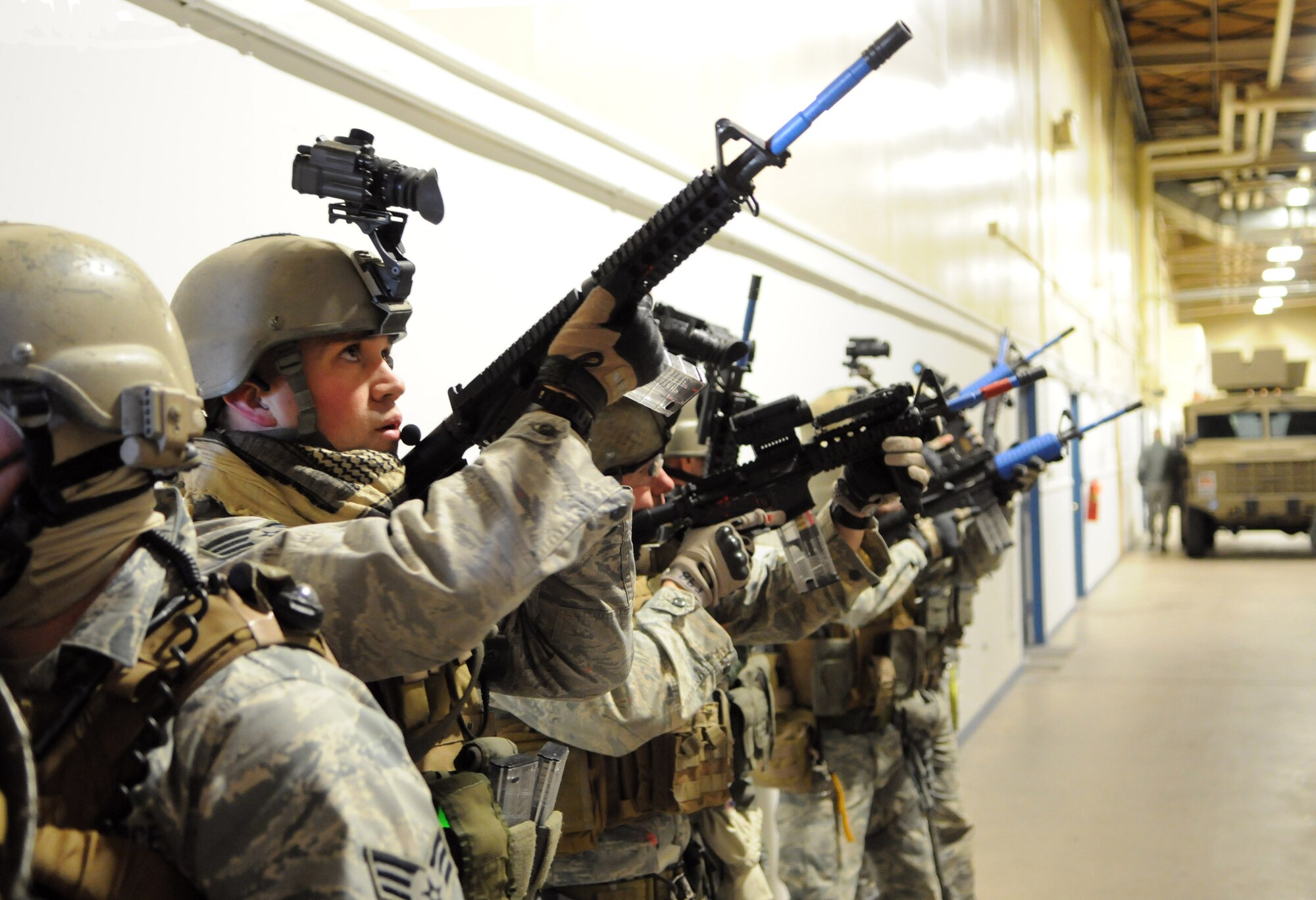 Senior Airman Colby Crosser and other members of the 90th SFG/TRF, run through a training scenario in the 37th Helicopter Squadron’s work spaces Feb. 2. After the TRF members practiced securing buildings in a training structure, the team moved on to practice securing the squadron’s spaces. (U.S. Air Force photo by R.J. Oriez)