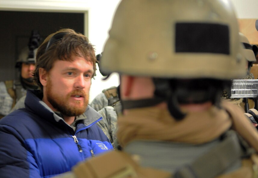 Todd Triplett, tactics instructor, briefs members of the 90th Security Forces Group Tactical Response Force before the start of a training scenario on F. E. Warren Air Force Base, Wyo., Feb. 2. The training area includes a structure with simulated rooms and doorways along with a catwalk instructors can use to watch the teams in action. (U.S. Air Force photo by R.J. Oriez)