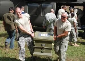 SOTO CANO AIR BASE, Honduras - 1Lt. Jonathan Snyder (left), physician assistant with Joint Task Force-Bravo's Medical Element, and MEDEL commander Col. (Dr.) Michael Hoilien, carry medical supplies, delivered by the 1-228th Aviation Regiment, during a medical readiness training exercise in Montana de la Flor Jan. 28.  The exercise was a coordinated effort between JTF-B, the Honduran Ministry of Health, the Honduran Army, Honduran Mission LeMars and volunteers from the University of South Dakota to to provide basic medical services to the people there. (U.S. Air Force photo/Capt. John T. Stamm)