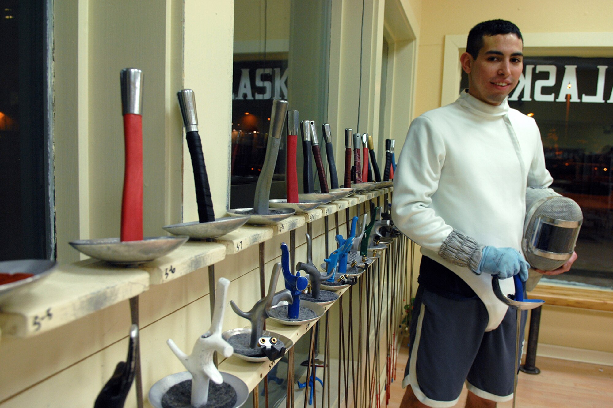 Airman 1st Class Devin Zayas poses for a photo following fencing practice, Feb. 3, 2011, at the Fencing Center of Alaska in Anchorage, Alaska. Airman Zayas is a network integration technician with the 673rd Communications Squadron. (U.S. Air Force photo/Staff Sgt. Jeremy Larlee)