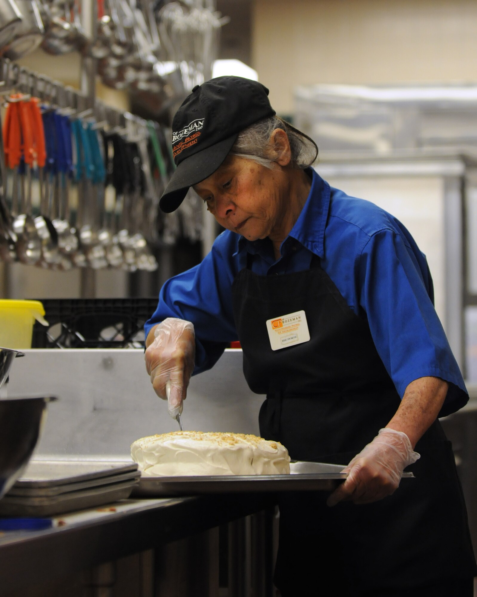 Bernie Tubbs, 90th FSS, cuts cake for lunch dessert at Chadwell Dining Facility on F. E. Warren Air Force Base, Wyo. Jan. 28. (U.S. Air Force photo by R.J. Oriez)