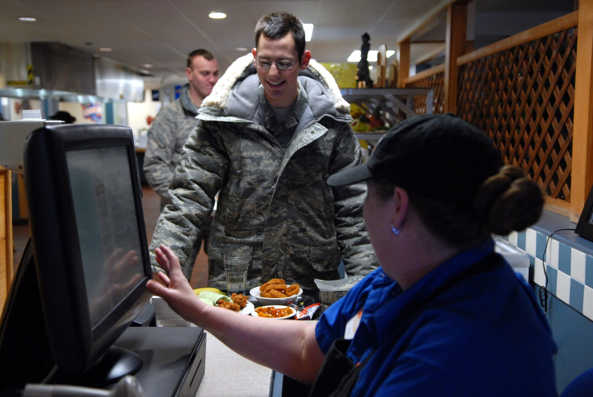 Cashier Rosie Hinds, 90th FSS, rings up Airman Daniel Ermis, 90th Missile Maintenance Squadron, lunch on the snack line at Chadwell Dining Facility on F. E. Warren Air Force Base, Wyo. Jan. 28. (U.S. Air Force photo by R.J. Oriez)