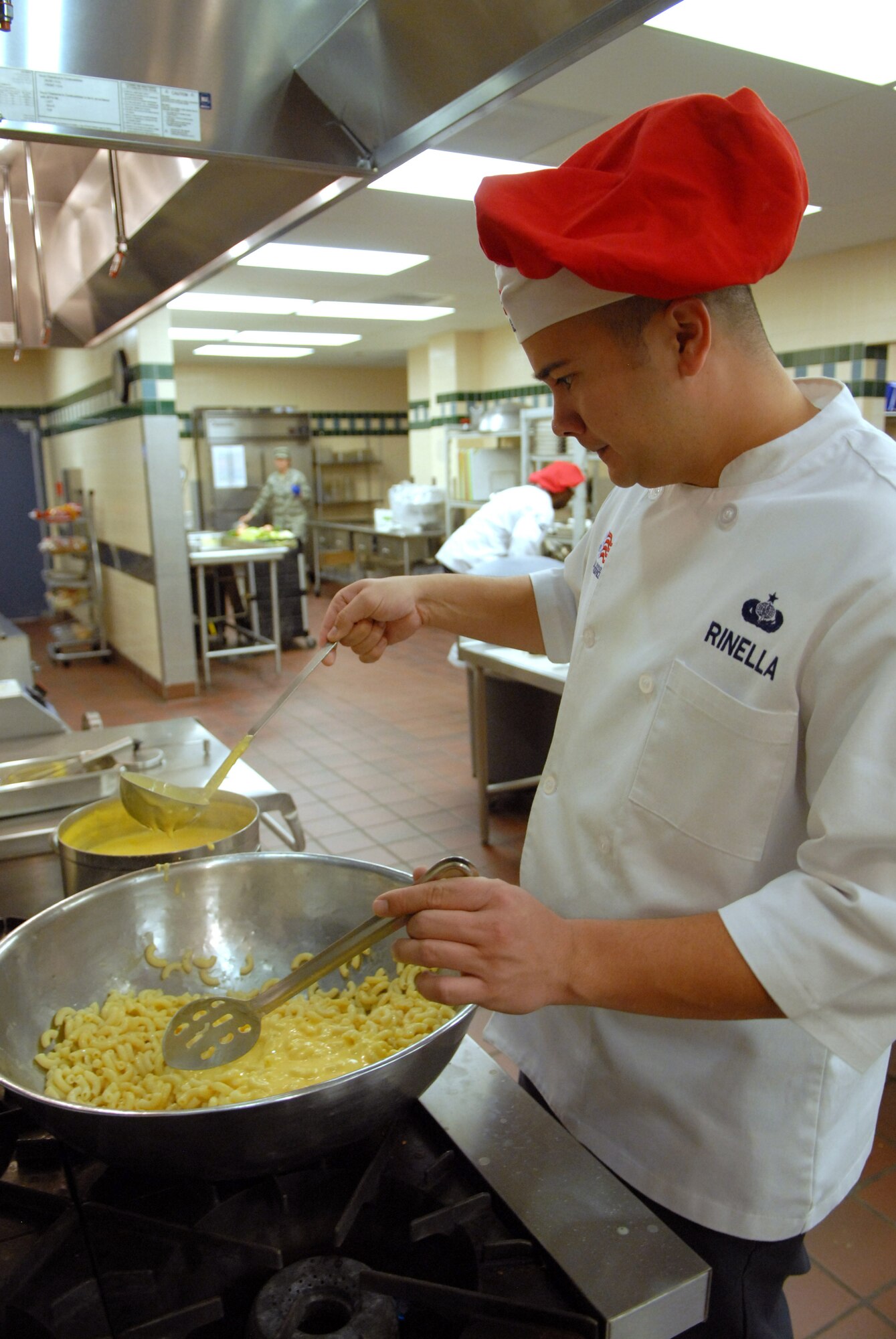 Tech. Sgt. Charles Rinella, 90th FSS, adds the cheese sauce he has just made to macaroni in preparation for lunch at Chadwell Dining Facility on F. E. Warren Air Force Base, Wyo. Jan. 28. (U.S. Air Force photo by R.J. Oriez)