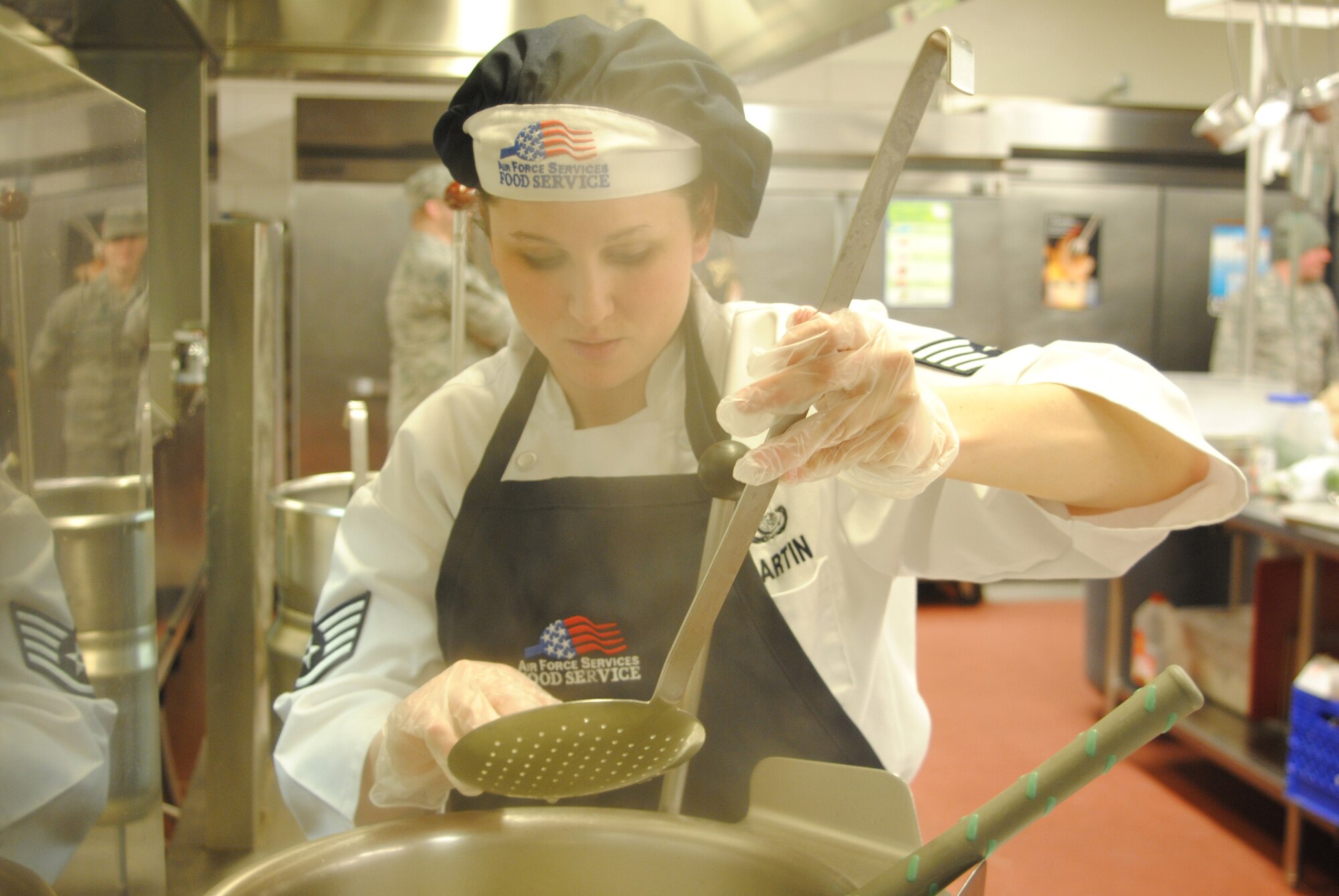 Staff Sgt. Chloe Martin, a 10th Missile Squadron missile chef, checks the tenderness of the jumbo shells that were used in the dish she helped prepare with her teammate from the 10th MS. Their meal went up agains four others in the first Warrior Chef competition for 2011. (U.S. Air Force photo/Airman Cortney Hansen)