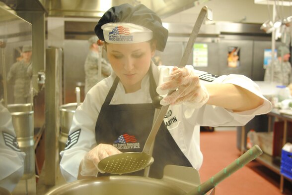 Staff Sgt. Chloe Martin, a 10th Missile Squadron missile chef, checks the tenderness of the jumbo shells that were used in the dish she helped prepare with her teammate from the 10th MS. Their meal went up agains four others in the first Warrior Chef competition for 2011. (U.S. Air Force photo/Airman Cortney Hansen)