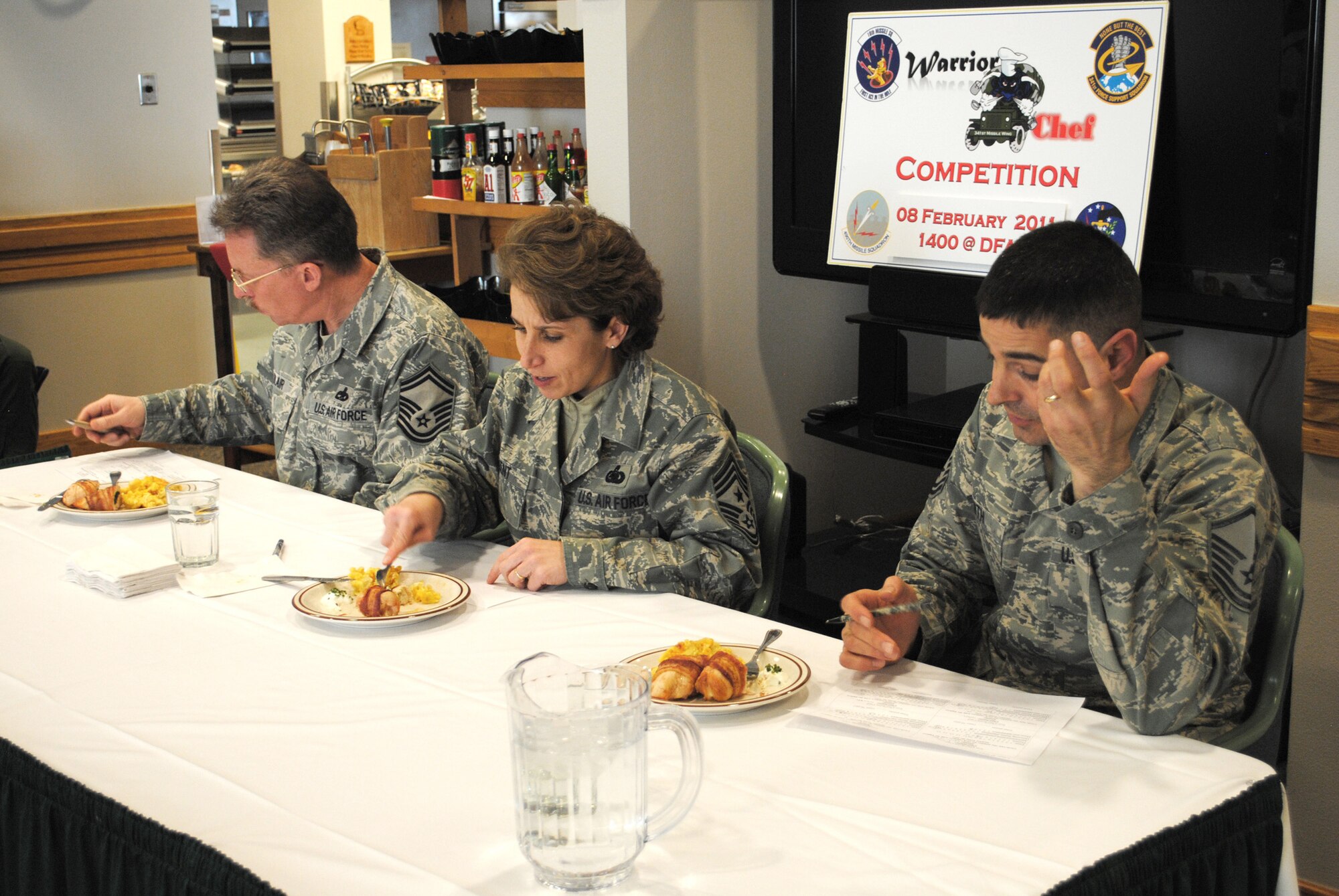 From left: Senior Master Sgt. Jerroll Blair, 341st Operations Group facility manager superintendant; Chief Master Sgt. Cari Kent, 341st Missile Wing command chief; and Master Sgt. William Smith, 341st FSS career assistance advisor, judge the final plate of the Warrior Chef competition.  Warrior Chef is held to recognize and reward Malmstrom's chefs through competition. (U.S. Air Force photo/Airman Cortney Hansen)