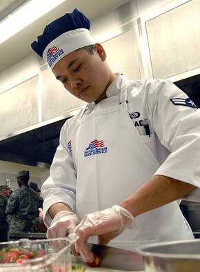 Airman 1st Class Louie Sabado, a Force Support Squadron services apprentice, chops strawberries for a desert that will be judged during the competition. (U.S. Air Force photo/Staff Sgt. Dillon White) 