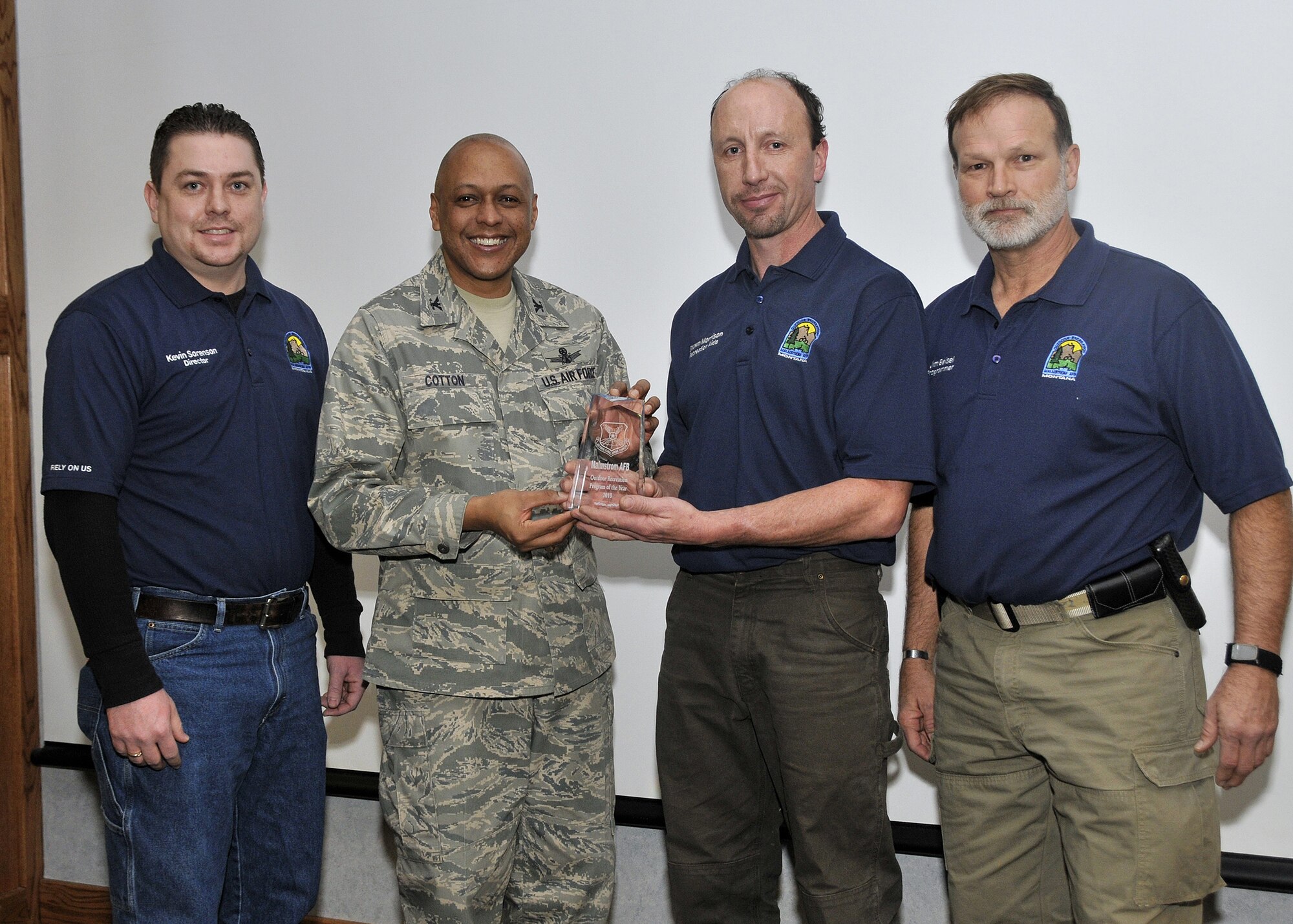 From left, Kevin Sorenson, Malmstrom Outdoor Recreation manager; Brig. gen. (Sel) Anthony Cotton, 341st Missile Wing commander; Shawn Morrison, ODR recreation aid, and Jim Beisel, ODR program manager, pause for a photo during an award presentation Feb. 2 in the wing conference room. The team won Air Force Global Strike Command's Outdoor Recreation program of the Year.  (U.S. Air Force photo/John Turner)