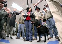 Kathy Rusk, mother of fallen Marine Pfc. Carlton Rusk, talks with media soon after adopting Eli, a military working dog. The dog was given to Rusk's family during a retirement and adoption ceremony at the Military Working Dog School Feb. 3. Eli and his handler, Pfc. Rusk, were in Afghanistan when the Marine was killed by Taliban sniper fire Dec. 6. (U.S. Air Force photo/Robbin Cresswell)