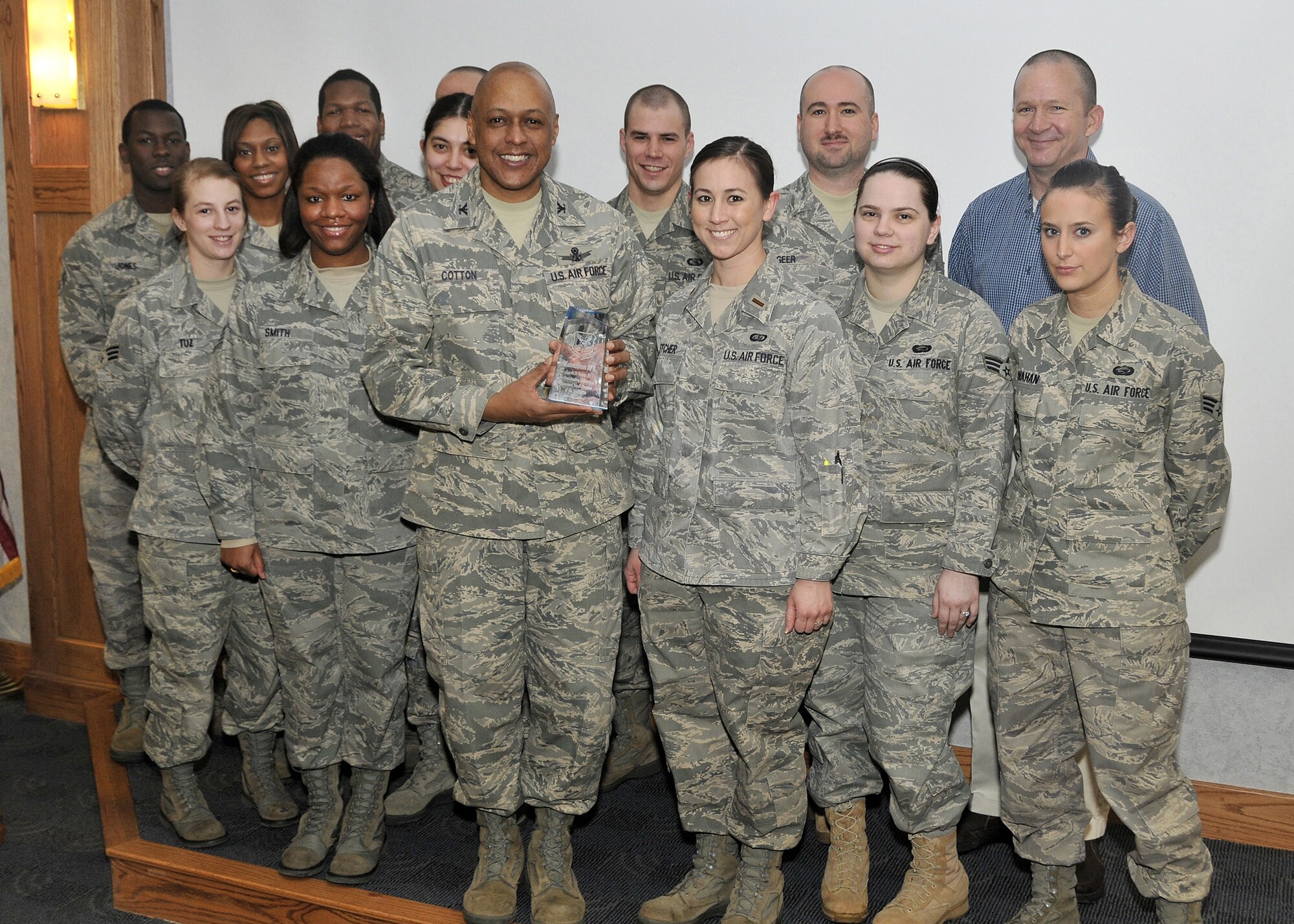 Brig. Gen. (Sel) Anthony Cotton, 341st Missile Wing commander, and the 341st Force Support Squadron Military Personnel Section stand for a photo during an awards presentation Feb. 2 in the wing conference room. The personnelists of Team Malmstrom won the Gerrit D. Foster, Jr. Outstanding Military Personnel Program award. (U.S. Air Force photo/John Turner)