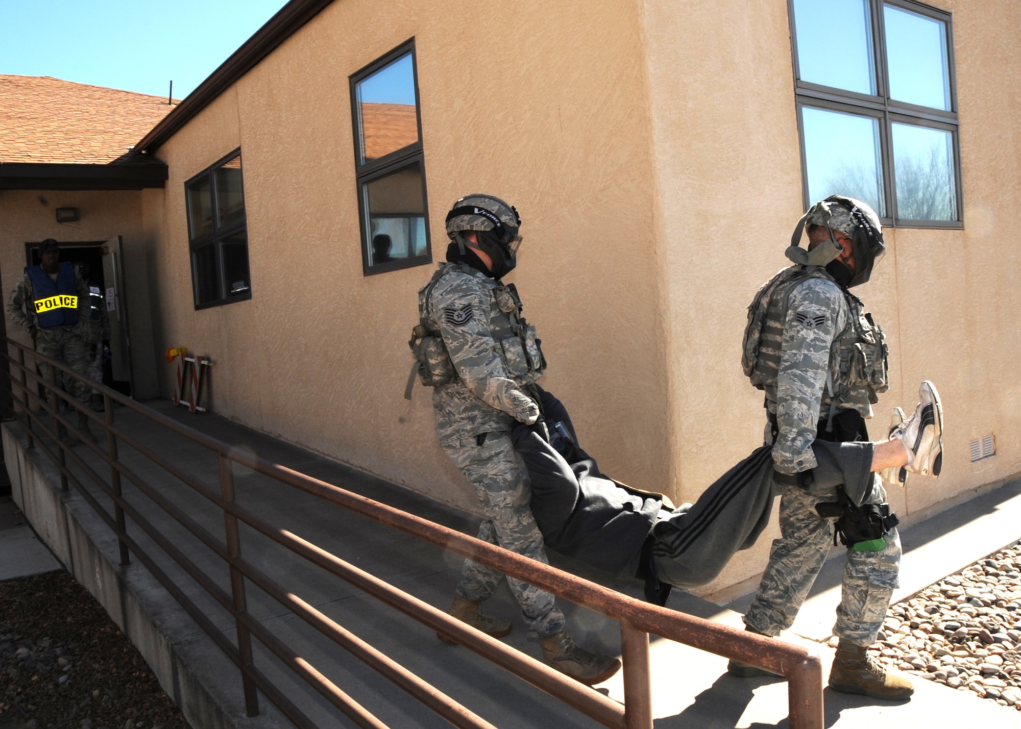 Two Airmen from Security Forces carry out a “shooter” during an active-shooter scenario Jan. 28. Other scenarios that took place during the operational readiness exercise were chalk deployment, a suspicious-package response and a fire in family housing.  U.S. Air Force Photo by Dennis Carlson.