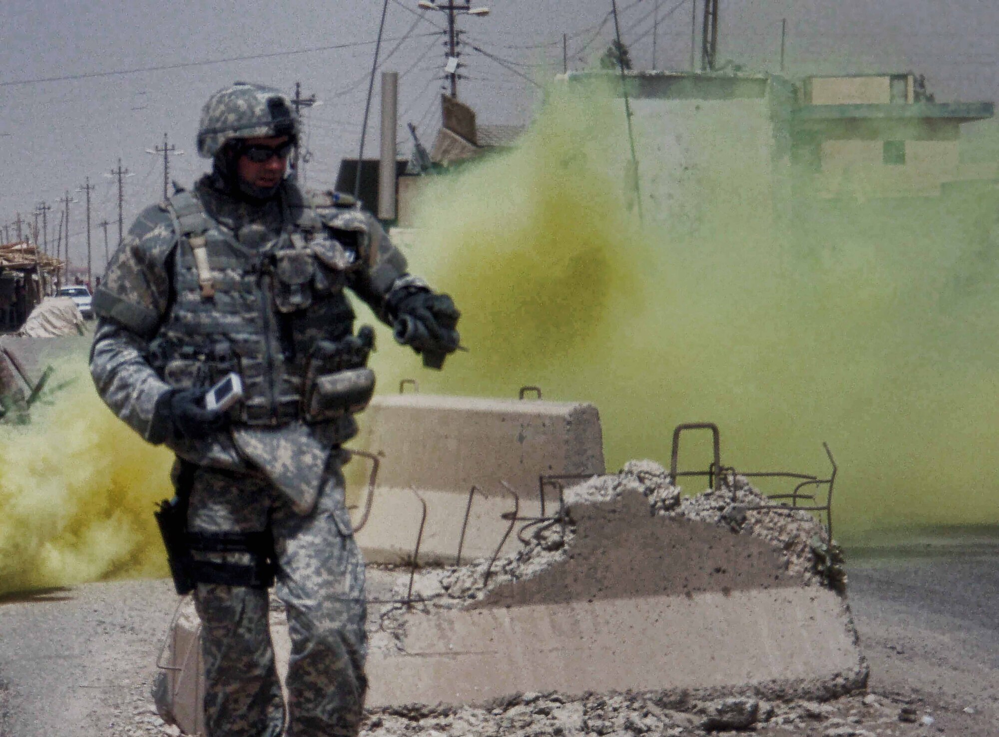 Tech. Sgt. Benjamin Horton, 75 Civil Engineer Group Explosive Ordnance Disposal team leader, responds to an attack on a security checkpoint July 7, 2007, in Kirkuk, Iraq. Due to rocket and sniper fire, Sergeant Horton used a smoke screen to provide cover. He was quickly able to neutralize several rockets that had failed to detonate. (U.S. Air Force photo by Staff Sgt. Glenn Henthorn)