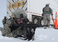 MINOT AIR FORCE BASE, N.D. -- Senior Airman Brian Bond, 791st Missile Security Forces Squadron fire team member, provides supporting security at the rear of a payload transporter as part of a training exercise during Prairie Sentry 11-2 here Feb. 2.  Exercises like this give Air Force Global Strike Command Airmen the opportunity to maintain their combat operation skills keen. (U.S. Air Force photo/Senior Airman Michael J. Veloz)