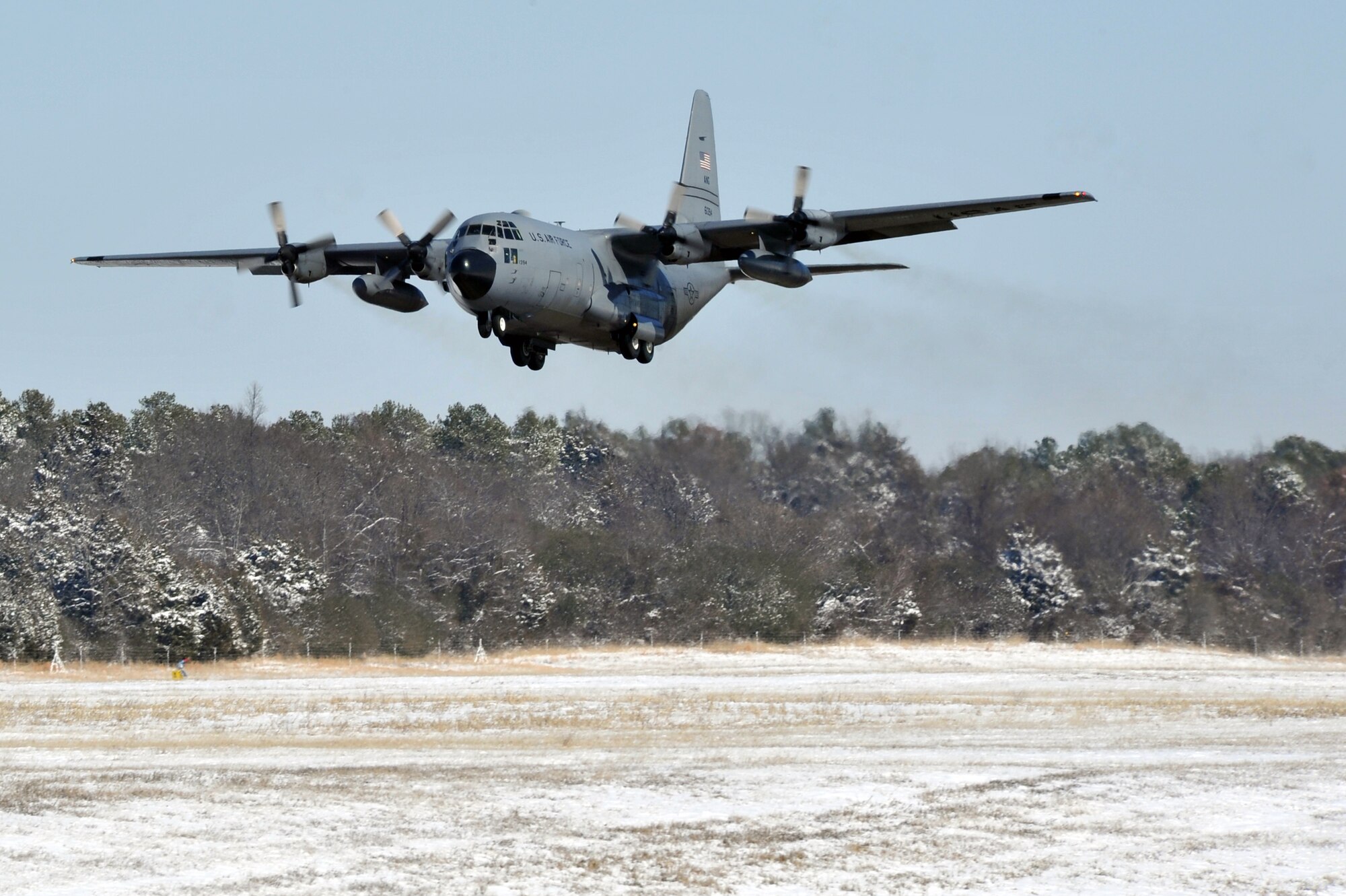 A C-130 Hercules takes off from the flightline Feb. 10, 2011, at Little Rock Air Force Base, Ark. Due to the efforts of numerous Team Little Rock members, the flightline was clear for continued base operations. (U.S. Air Force photo by Staff Sgt. Chris Willis)