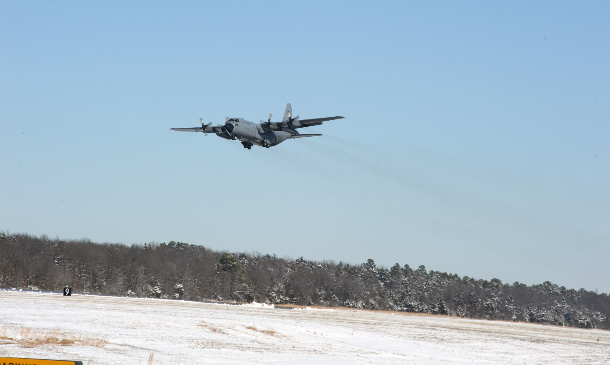A C-130 Hercules takes off from the flightline Feb. 10, 2011, at Little Rock Air Force Base, Ark. Airmen enabled flying operations by clearing aircraft and the flightline of snow. (Air Force photo by Airman 1st Class Ellora Stewart)