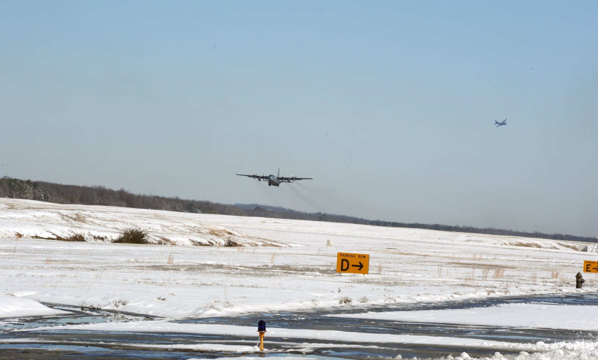 A C-130 Hercules takes off from the flightline Feb. 10, 2011, at Little Rock Air Force Base, Ark. Airmen enabled flying operations by clearing aircraft and the flightline of snow. (Air Force photo by Airman 1st Class Ellora Stewart)