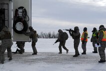MINOT AIR FORCE BASE, N.D. -- Members of the 791st Missile Security Forces Squadron, purge the back door of a payload transporter while evaluators look on as part of a training exercise during Prairie Sentry 11-2 here Feb. 2.  Exercises like this give Air Force Global Strike Command Airmen the opportunity to maintain their combat operation skills. (U.S. Air Force photo/Senior Airman Michael J. Veloz)