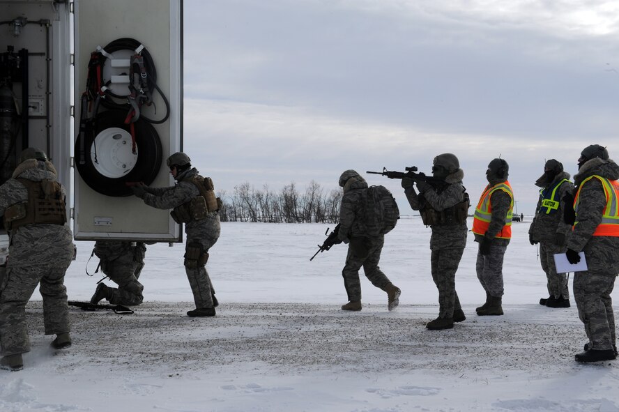MINOT AIR FORCE BASE, N.D. -- Members of the 791st Missile Security Forces Squadron, purge the back door of a payload transporter while evaluators look on as part of a training exercise during Prairie Sentry 11-2 here Feb. 2.  Exercises like this give Air Force Global Strike Command Airmen the opportunity to maintain their combat operation skills. (U.S. Air Force photo/Senior Airman Michael J. Veloz)