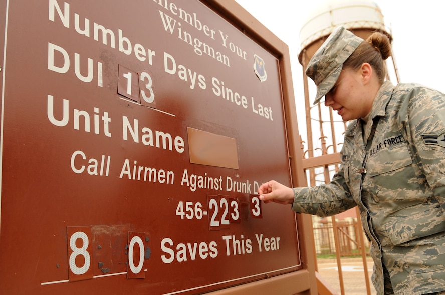 Airman 1st Class Megan France, Airman Against Drunk Driving treasurer, changes the AADD phone number on a Barksdale sign that is designed to encourage Airmen who are leaving the base to use the service for a safe, reliable ride home.  The AADD phone number was changed to 318-456-AADD (2233) in an effort to provide a more memorable contact number. (U.S. Air Force photo/Senior Airman Allison M. Boehm)(RELEASED)