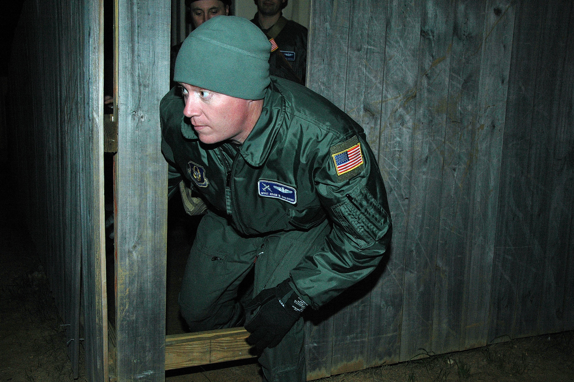 Staff Sergeant Chad Braunschweig, SERE Specialist with the 908th Operations Group, assisted by fellow specialists and civilian contractors, recently conducted combat survival training for members of the 908th Airlift Wing. Above, Master Sgt. Adam Childers checks to see if the way is clear during the escape and evasion exercise. (Air Force photo by Tech. Sgt. Jay Ponder)