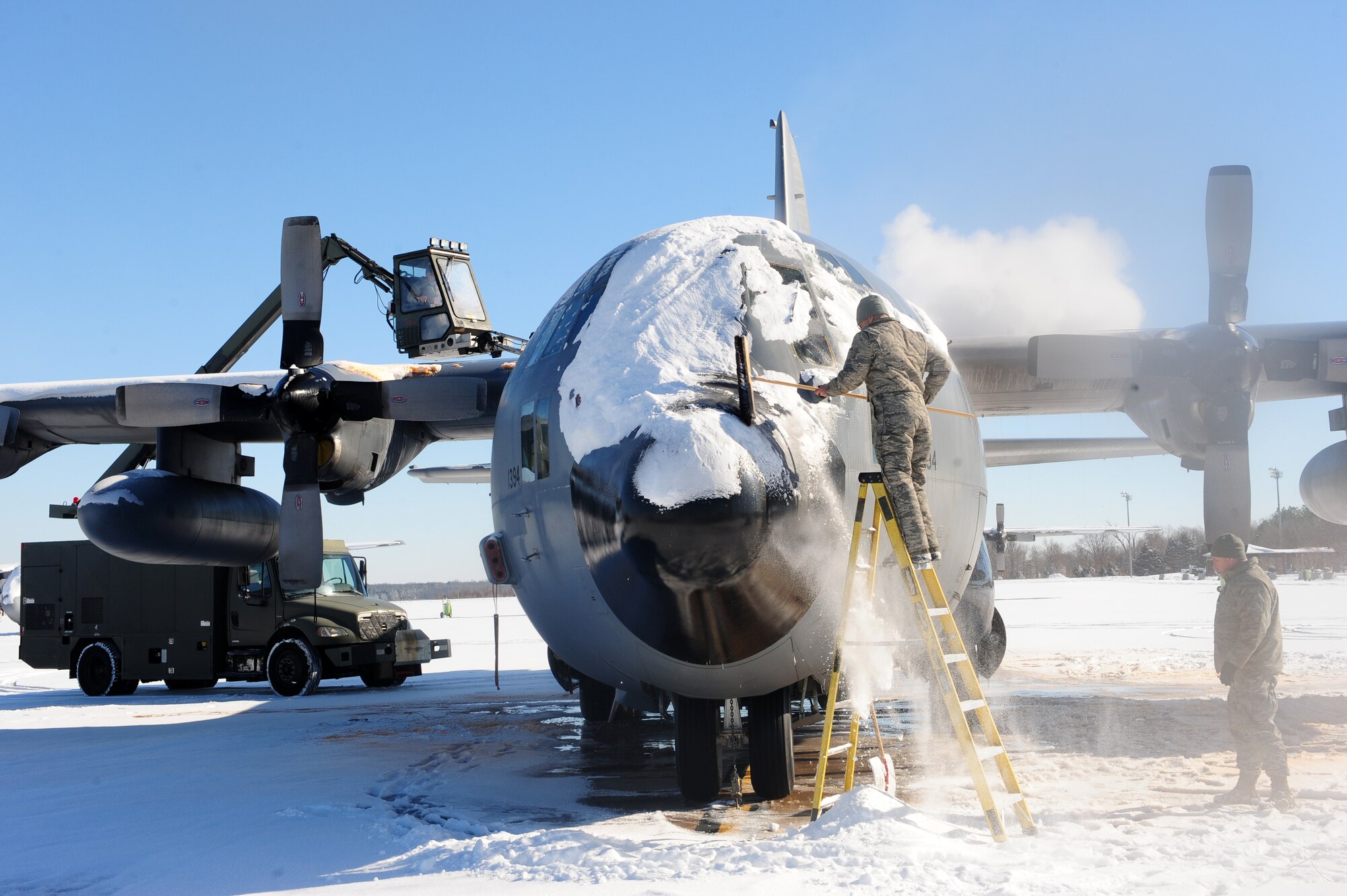 Airmen from 189th Aircraft Maintenance Squadron thaw out a C-130 Feb. 10, 2011, at Little Rock Air Force Base, Ark. The Airmen of Little Rock Air Force Base overcame six inches of snow to keep aircraft ready to fly. (Photo by U.S. Air Force Senior Airman Jim Araos)