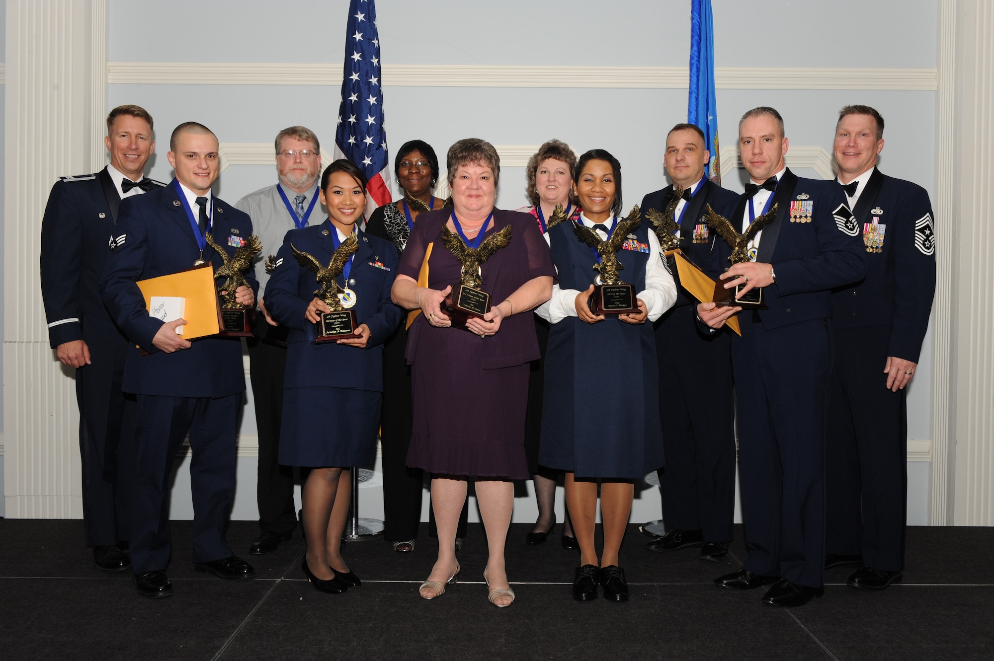 SEYMOUR JOHNSON AIR FORCE BASE, N.C. – Annual award winners from the 4th Fighter Wing pose for a photo with members of base leadership after the wing’s annual awards banquet Feb. 5, 2011. The Airmen and civilians who took home trophies will now compete in the 9th Air Force annual awards competition. (U.S. Air Force photo/Staff Sgt. Courtney Richardson) (RELEASED)