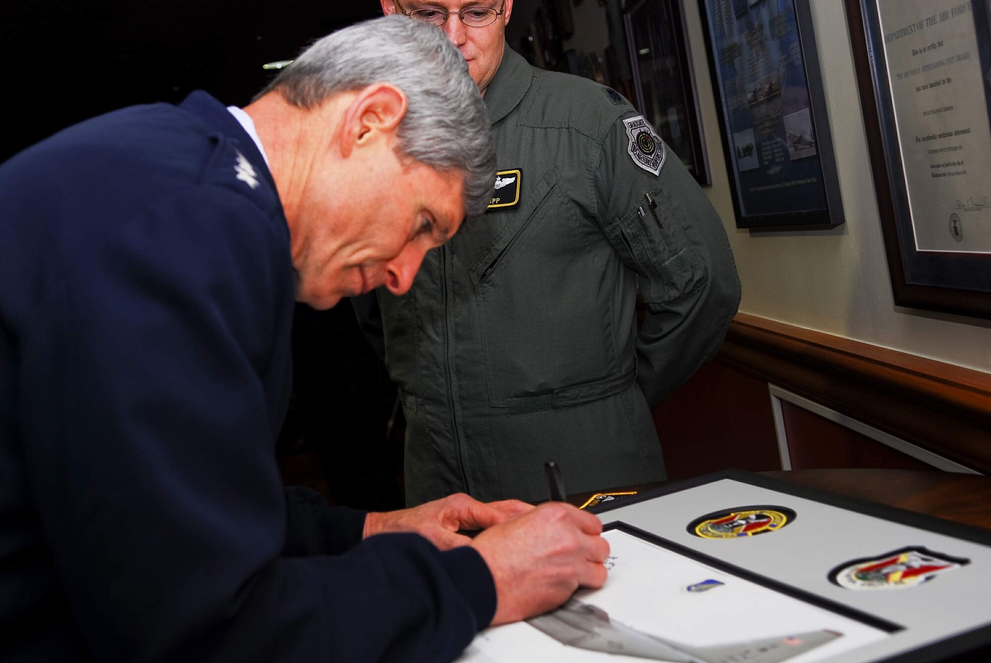 Air Force Chief of Staff Gen. Norton Schwartz signs a lithograph for the 36th Airlift Squadron during a visit to Feb. 8, 2011, at Yokota Air Base. General Schwartz visited Airmen to discuss issues affecting the Air Force in 2011. (U.S. Air Force photo/Airman 1st Class Lynsie Nichols)
