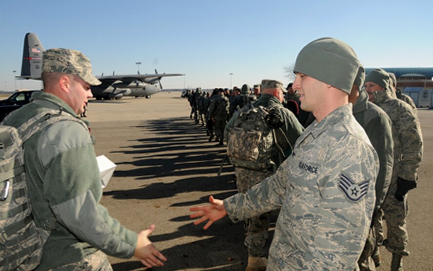 178 FW SFS members prepare to load on a C-130 Hercules for training prior to deploying to Iraq in support of Operation New Dawn Jan. 4.