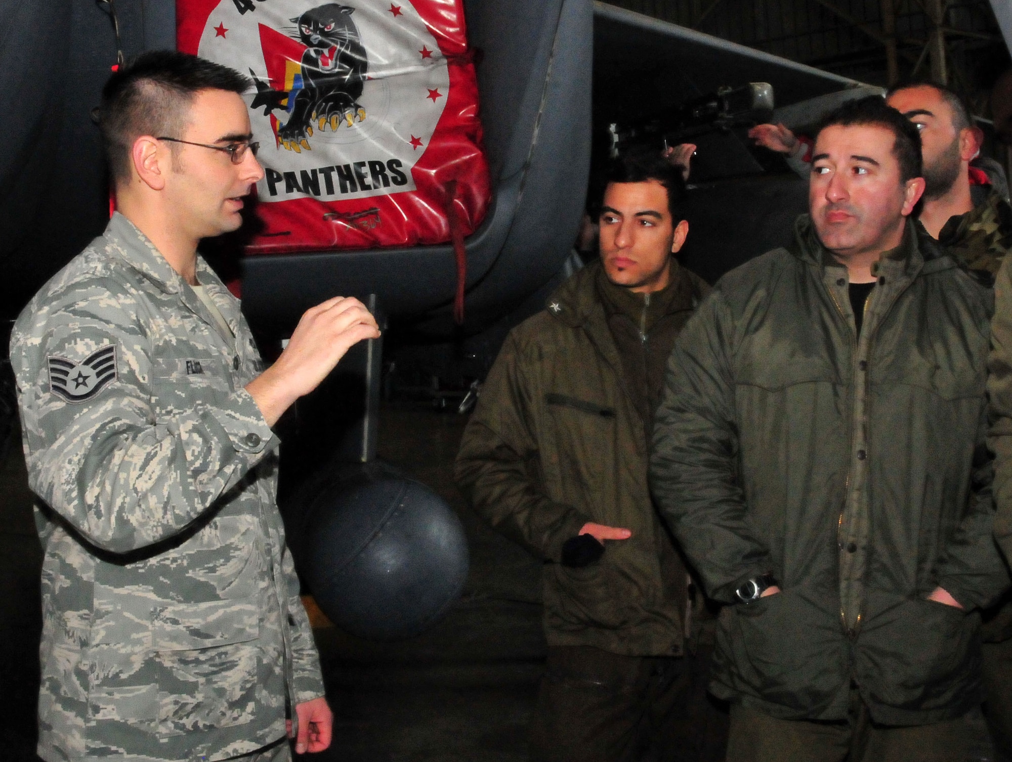 DECIMOMANNU AIR BASE, Italy -- Staff Sgt. David Flick, 48th Civil Engineer Squadron firefighter, trains Italian military firefighters on F-15E Strike Eagle emergency procedures at Decimomannu Air Base, Italy, Feb. 3. Originally from Italy, Sergeant Flick deployed to the Italian island of Sardinia with the 494th Fighter Squadron to help train firefighters for a week. Due to his Italian language expertise, he stayed for the entire training exercise to work as an interpreter. (U.S. Air Force photo/ Staff Sgt. Megan P. Lyon)