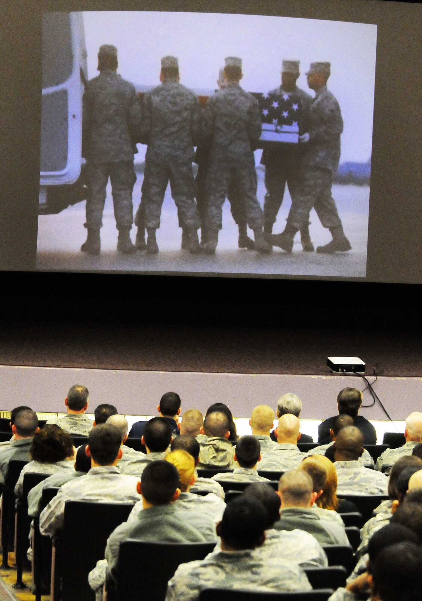 Members of the 5th Combat Communications Group view slides of the dignified transfer of A1C Austin Gates-Benson. Airman Gates-Benson served with the 54th CBCS. U. S. Air Force photo by Sue Sapp