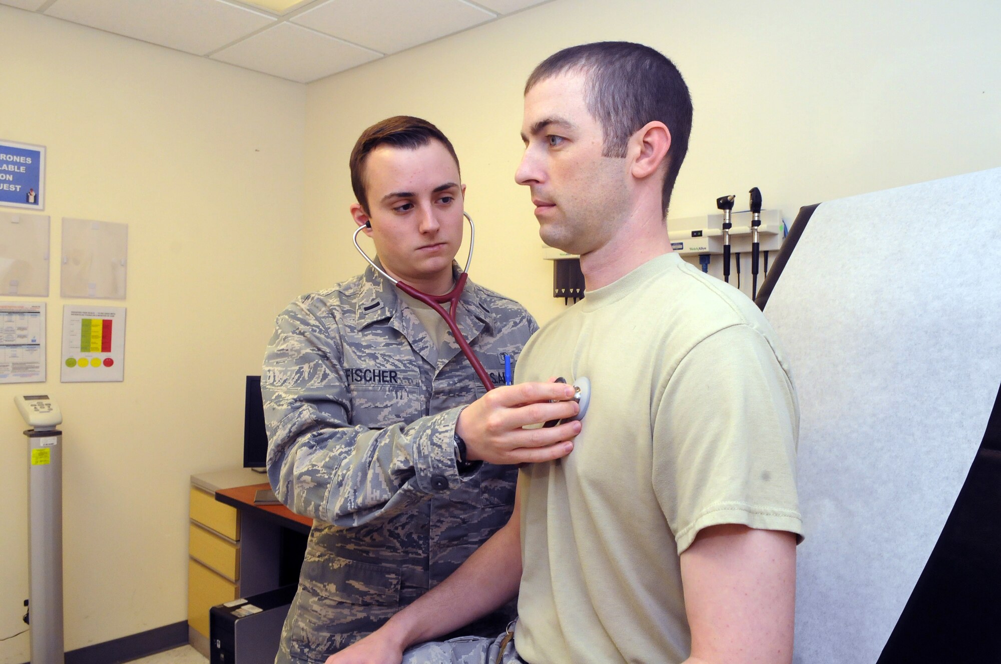 1st. Lt. Taylor Fischer, physician assistant, does a heart and lung check on SSgt. James Edwards. U. S. Air Force photo by Sue Sapp