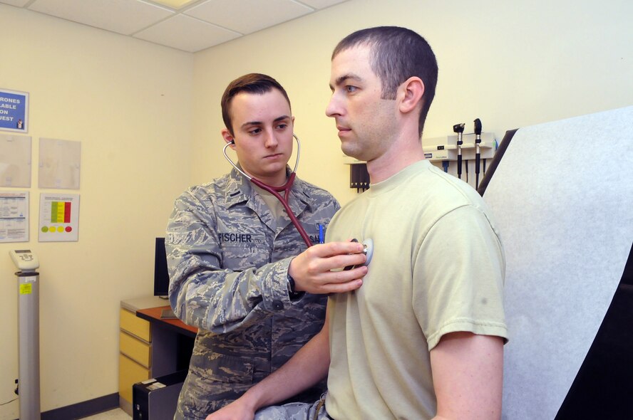 1st. Lt. Taylor Fischer, physician assistant, does a heart and lung check on SSgt. James Edwards. U. S. Air Force photo by Sue Sapp