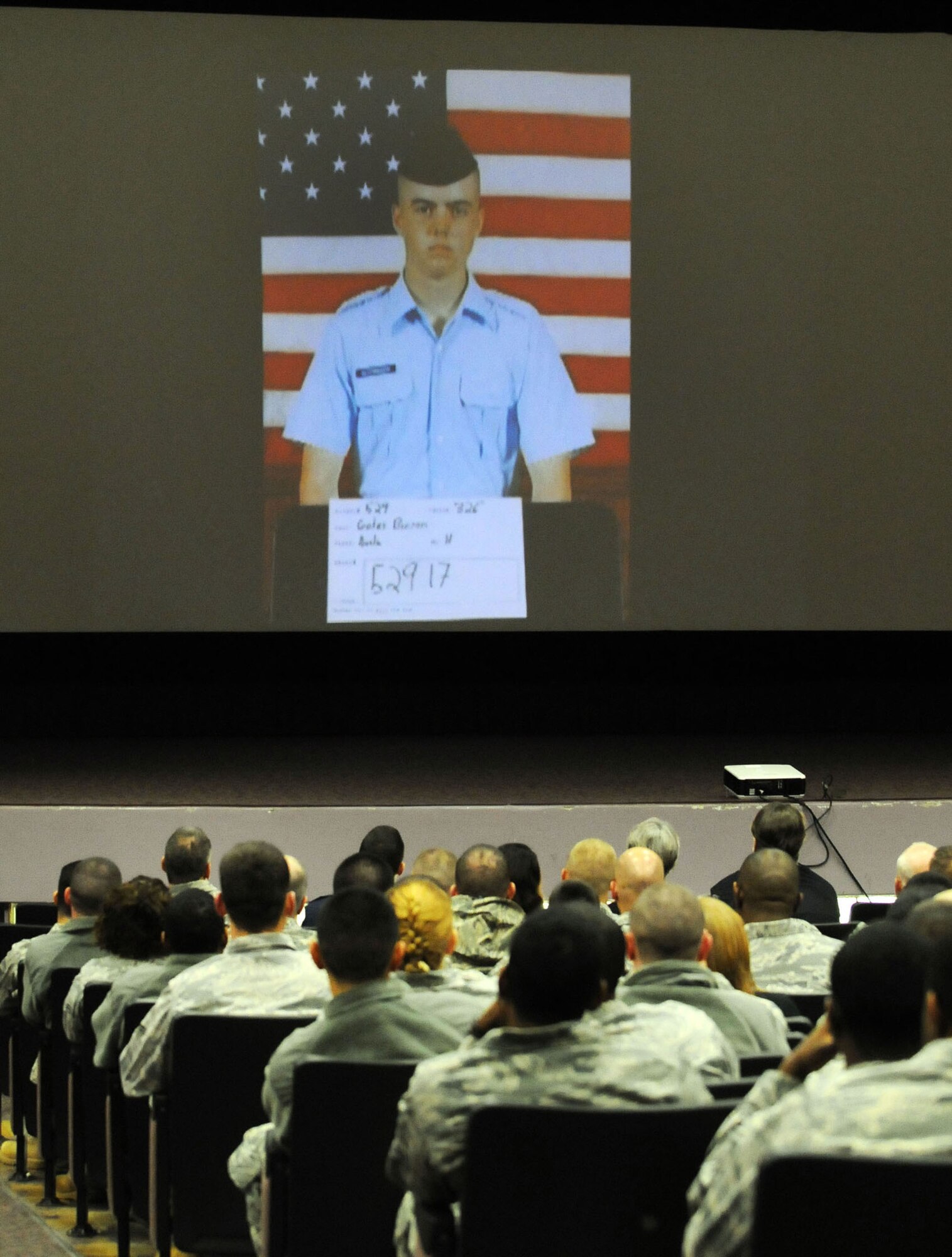 Members of the 5th Combat Communications Group view slides of the life of A1C Austin Gates-Benson. Airman Gates-Benson served with the 54th CBCS. U. S. Air Force photo by Sue Sapp