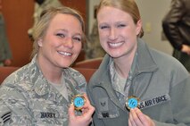 Senior Airman Nicole Barry, 916th Operations Support Squadron and Senior Airman Anne Hand, 916th Security Forces Squadron, were both coined by Air Mobility Command's Inspection General, Brig. Gen. Richard Klumpp, for their outstanding performance at the wing's Operational Readiness Inspection. (USAF photo by Maj. Shannon Mann, 916ARW/PA)