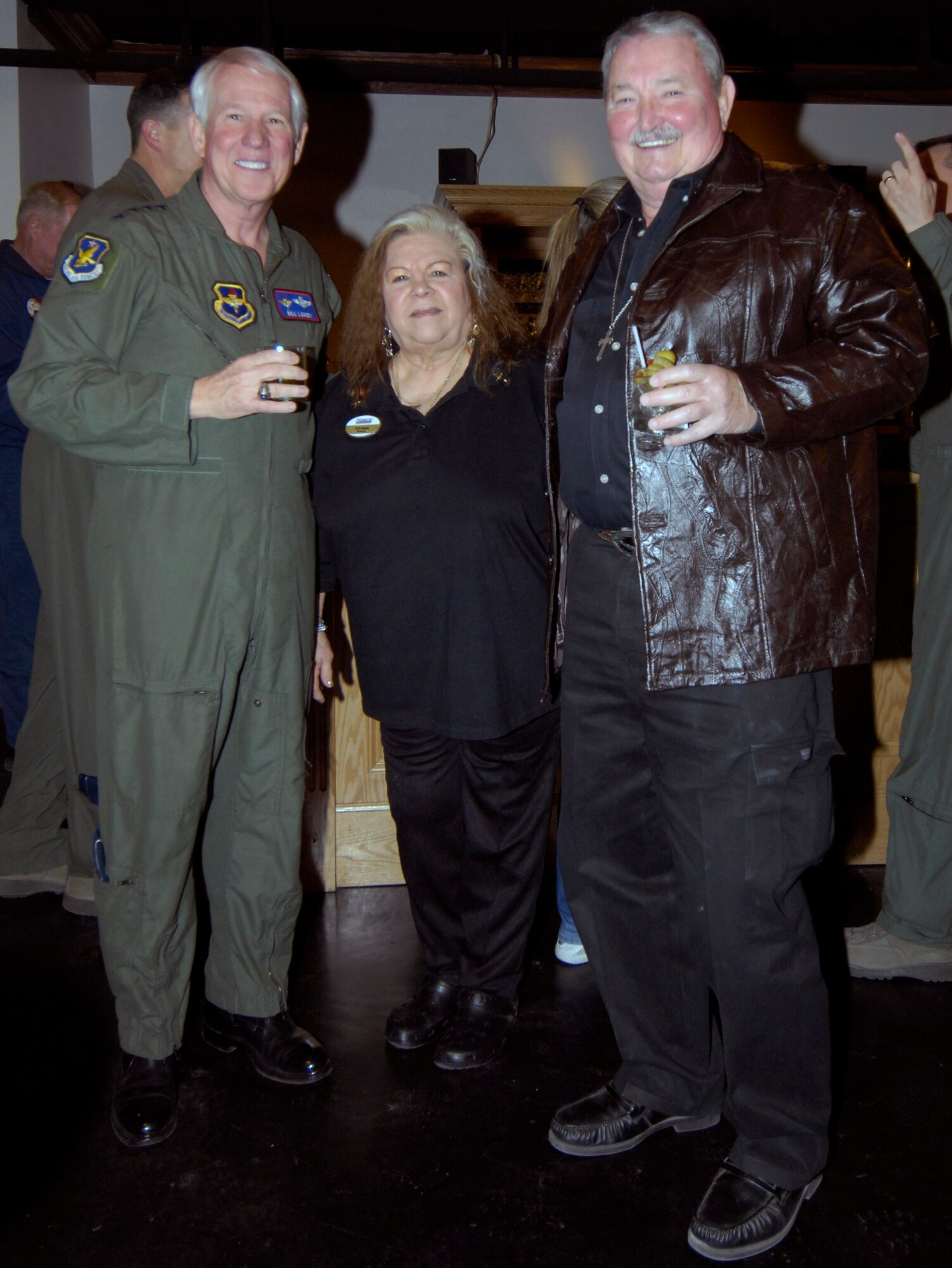 LAUGHLIN AIR FORCE BASE, Texas — Retired Gen. William Looney and retired Maj. Gen. Gerald Prather pose with Yolanda “YoYo” Meaze, a bartender at Club XL. General Looney performed the ribbon cutting ceremony for Club XL’s bar grand reopening Feb. 4. (U.S. Air Force photo by Jose Mendoza)