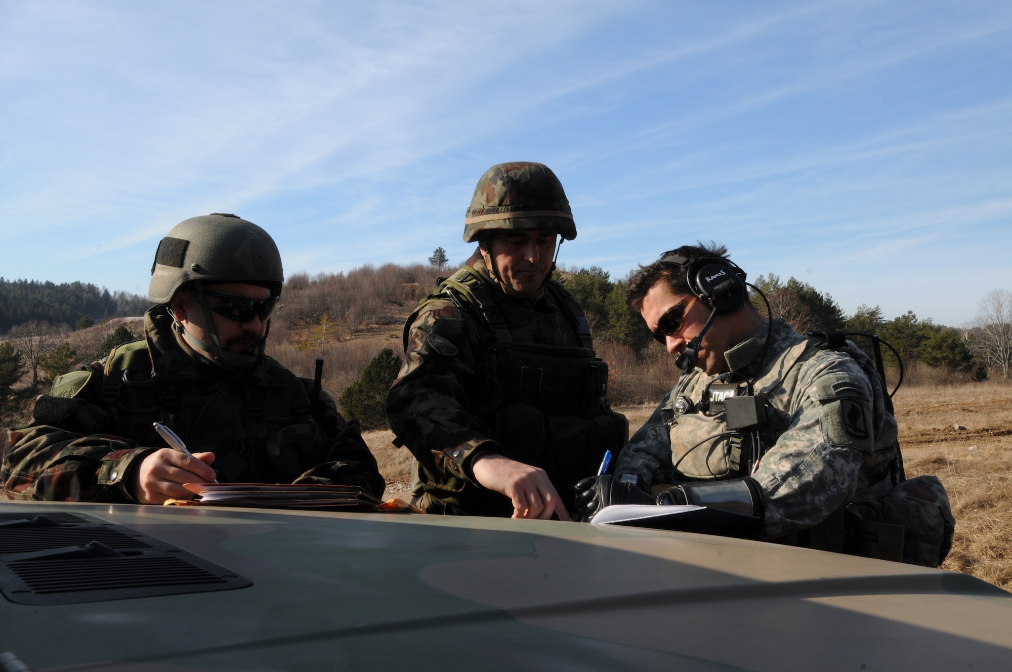 Tech. Sgt. Eduardo Ramos, 8th Air Support Operations Squadron joint terminal attack contoller, provides training feedback to Slovenian army Sgt. 1st Class Sergej Savov and Staff Sgt. Rudolf Rot, JTACs, on lessons learned during a NATO coalition combat capability training exercise at Pocek Range in Postojna, Slovenia, Feb. 4. The exercise consisted of close air support training between Aviano Air Base, Italy,  and Slovenian army joint terminal attacks controllers and tactical air control party operators as well as Slovenian PC-9M aircraft.(U.S. Air Force photo/ Staff Sgt. Nadine Y. Barclay)