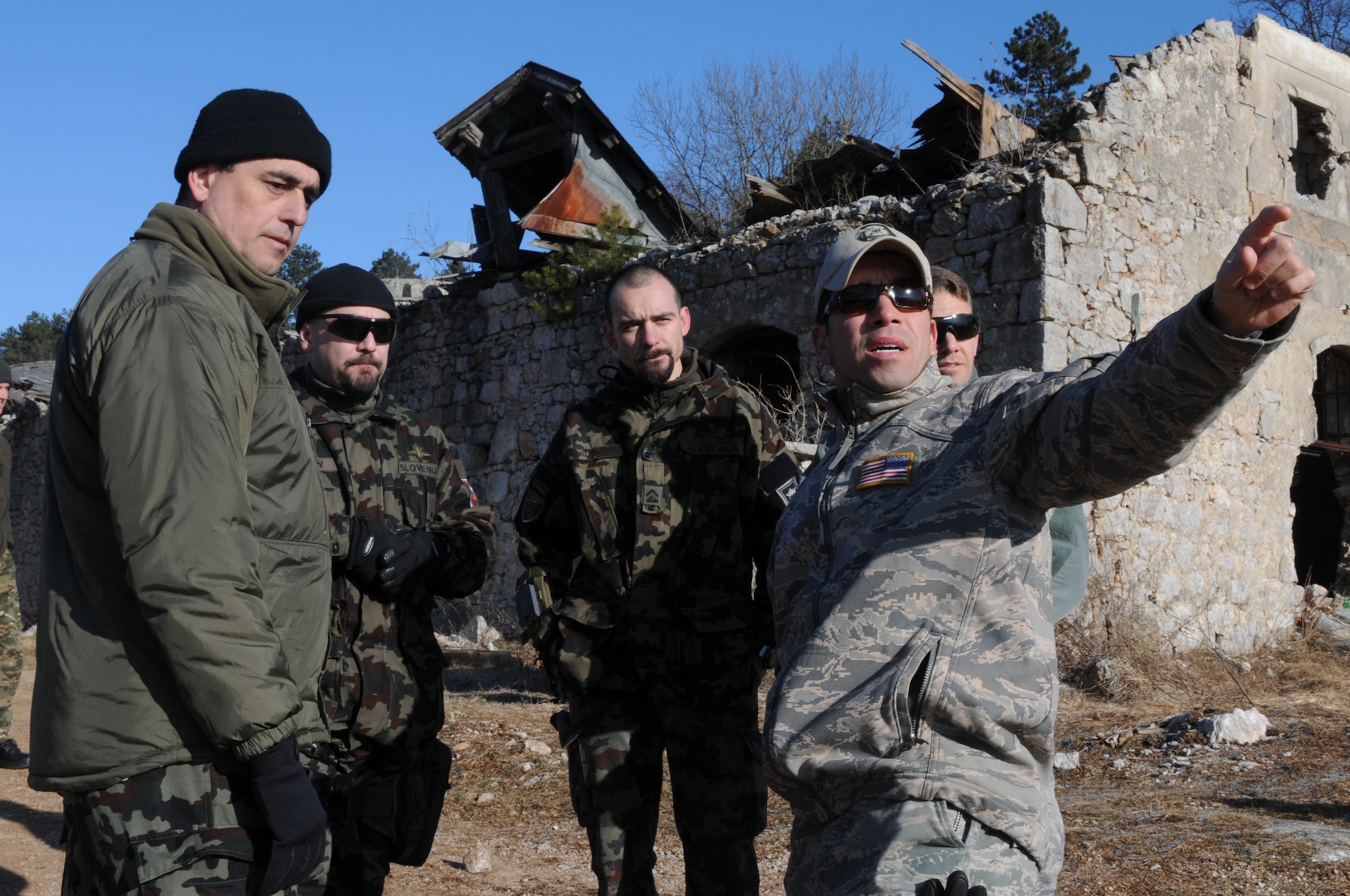 Tech. Sgt. Eduardo Ramos, 8th Air Support Operations Squadron joint terminal attack contoller, explains the sequence of events to three Slovenian army JTACs during a NATO coalition combat capability training exercise at Pocek Range in Postojna, Slovenia, Feb. 2. The exercise consisted of close air support training between Aviano Air Base, Italy,  and Slovenian army joint terminal attacks controllers and tactical air control party operators as well as Slovenian PC-9M aircraft.(U.S. Air Force photo/ Staff Sgt. Nadine Y. Barclay)