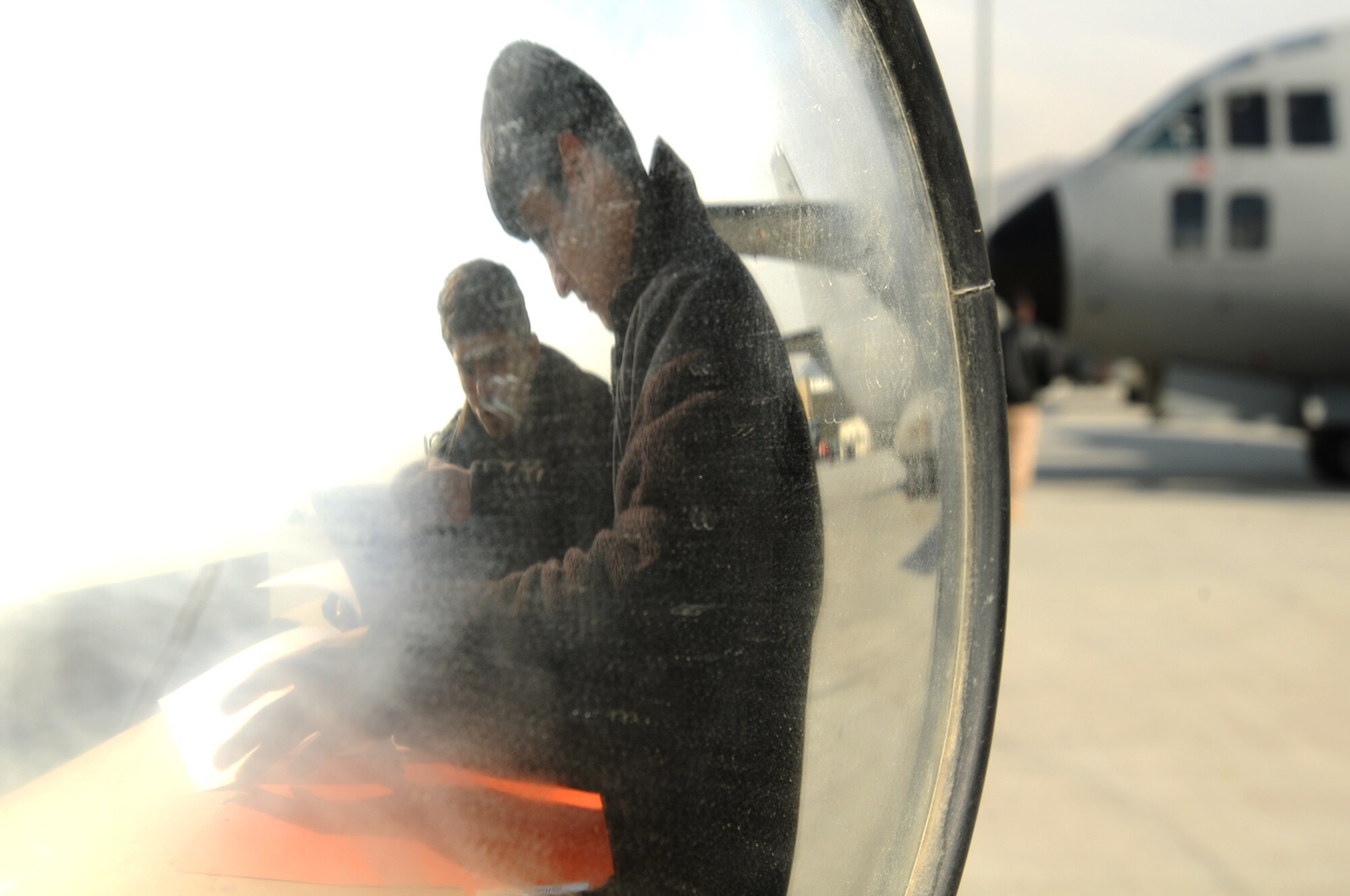 Afghan Air Force Airmen practice taking down aircraft maintenance documentation during a training session held by the initial cadre of AAF C-27 maintenance on-the-job trainers at the Afghan Air Force Base in Kabul, Afghanistan Feb. 9. (U.S. Navy photo by Mass Communications Specialist 2nd Class Vladimir Potapenko)